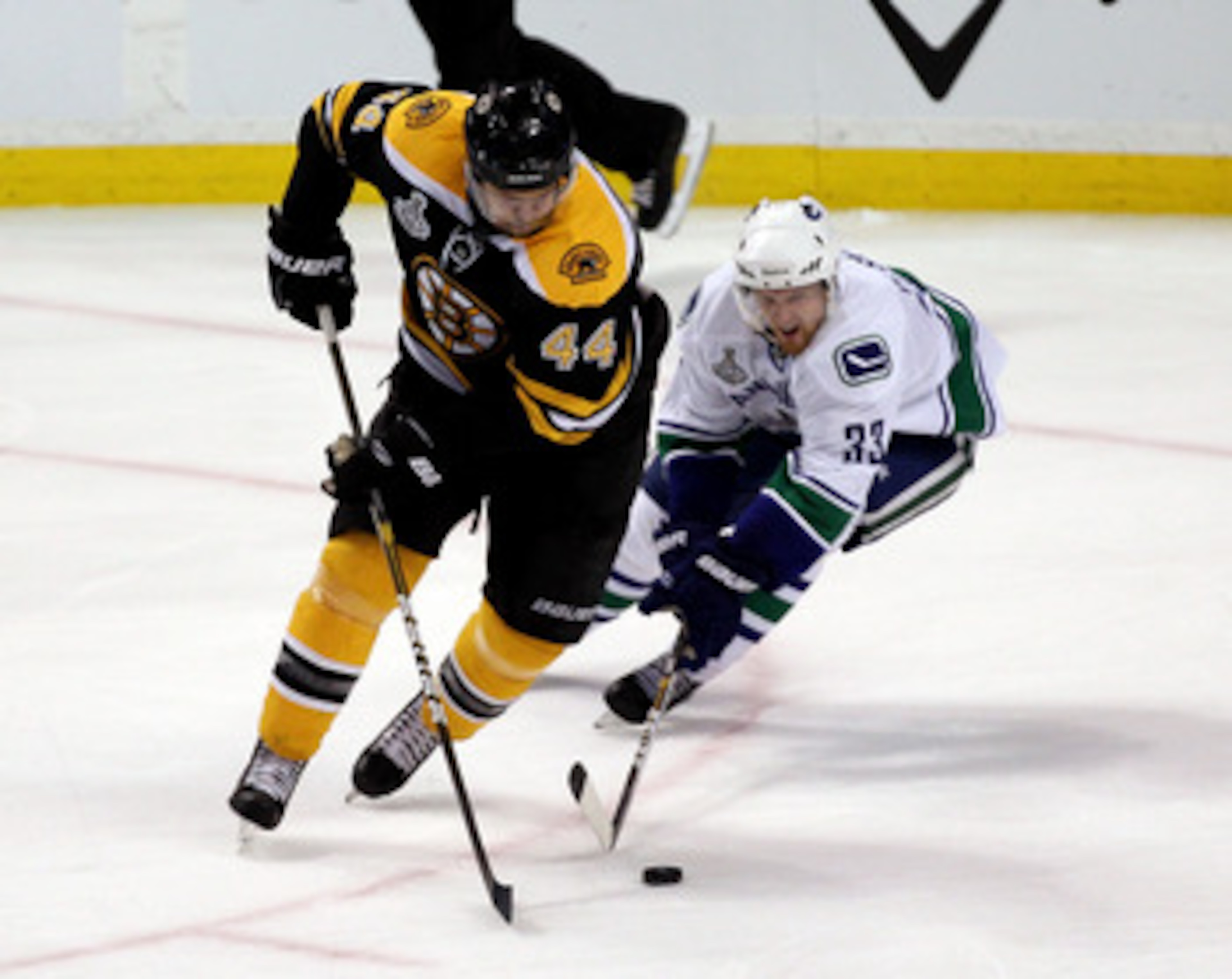 BOSTON, MA - JUNE 06:  Dennis Seidenberg #44 of the Boston Bruins against Henrik Sedin #33 of the Vancouver Canucks during Game Three of the 2011 NHL Stanley Cup Final at TD Garden on June 6, 2011 in Boston, Massachusetts.  (Photo by Jim Rogash/Getty Imag