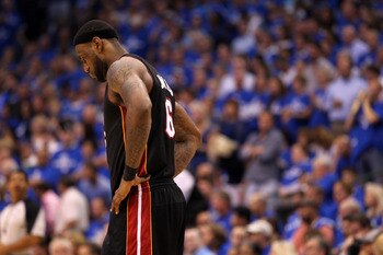 DALLAS, TX - JUNE 09:  LeBron James #6 of the Miami Heat stands on the court with his head down against the Dallas Mavericks in the fourth quarter of Game Five of the 2011 NBA Finals at American Airlines Center on June 9, 2011 in Dallas, Texas.  NOTE TO U