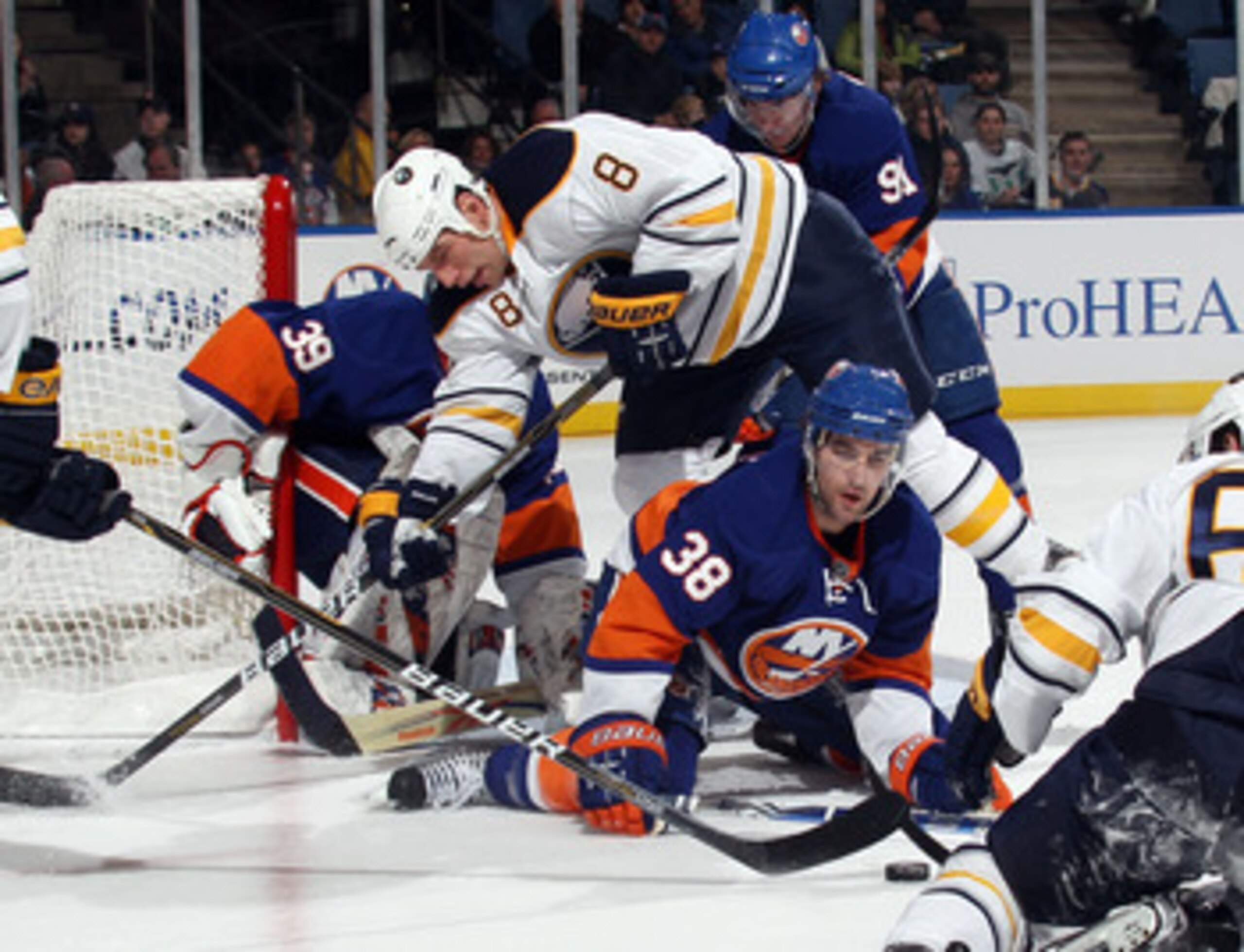 UNIONDALE, NY - JANUARY 15: Cody McCormick #8 of the Buffalo Sabres goes over the top of Jack Hillen #38 of the New York Islanders as he attempts to block a shot at the Nassau Coliseum on January 15, 2011 in Uniondale, New York.  (Photo by Bruce Bennett/G