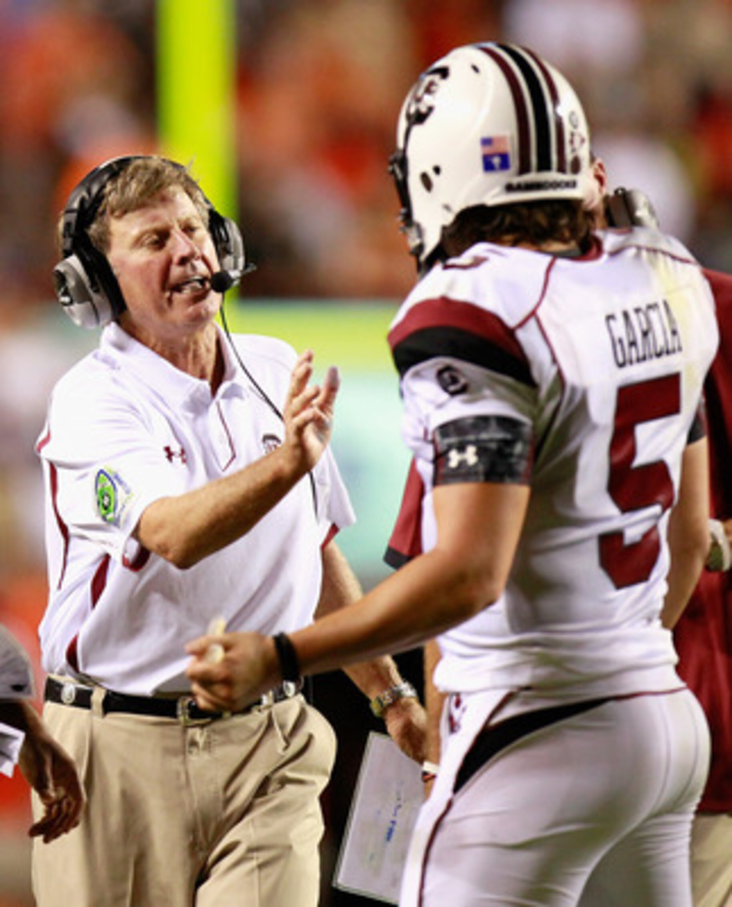 AUBURN, AL - SEPTEMBER 25:  Head coach Steve Spurrier of the South Carolina Gamecocks walks to congratulate quarterback Stephen Garcia #5 for his passing touchdown against the Auburn Tigers at Jordan-Hare Stadium on September 25, 2010 in Auburn, Alabama.