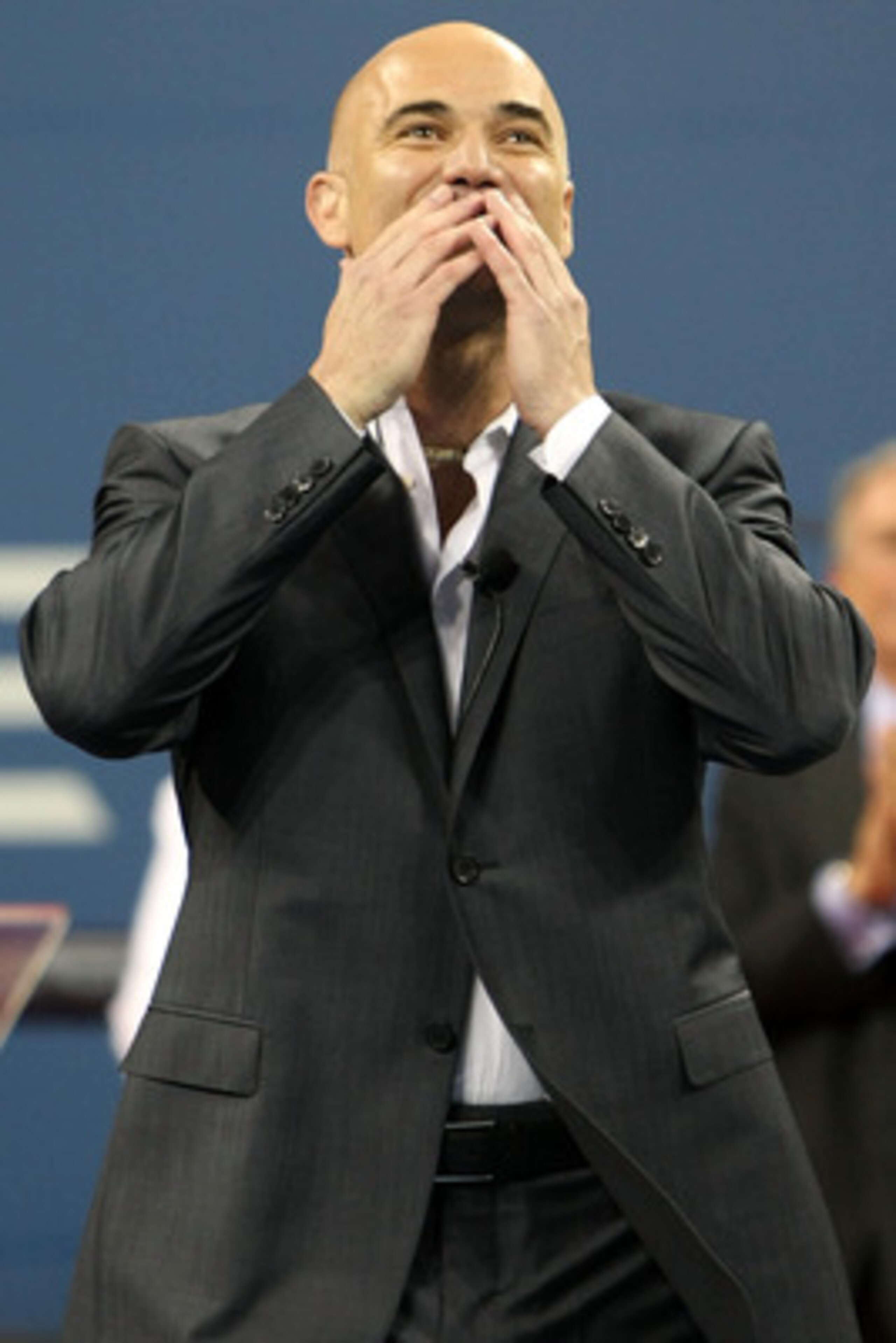 NEW YORK - AUGUST 31:  Andre Agassi acknowledges the crowd during the Opening Ceremony of the 2009 U.S. Open at the USTA Billie Jean King National Tennis Center on August 31, 2009 in Flushing neighborhood of the Queens borough of New York City.  (Photo by