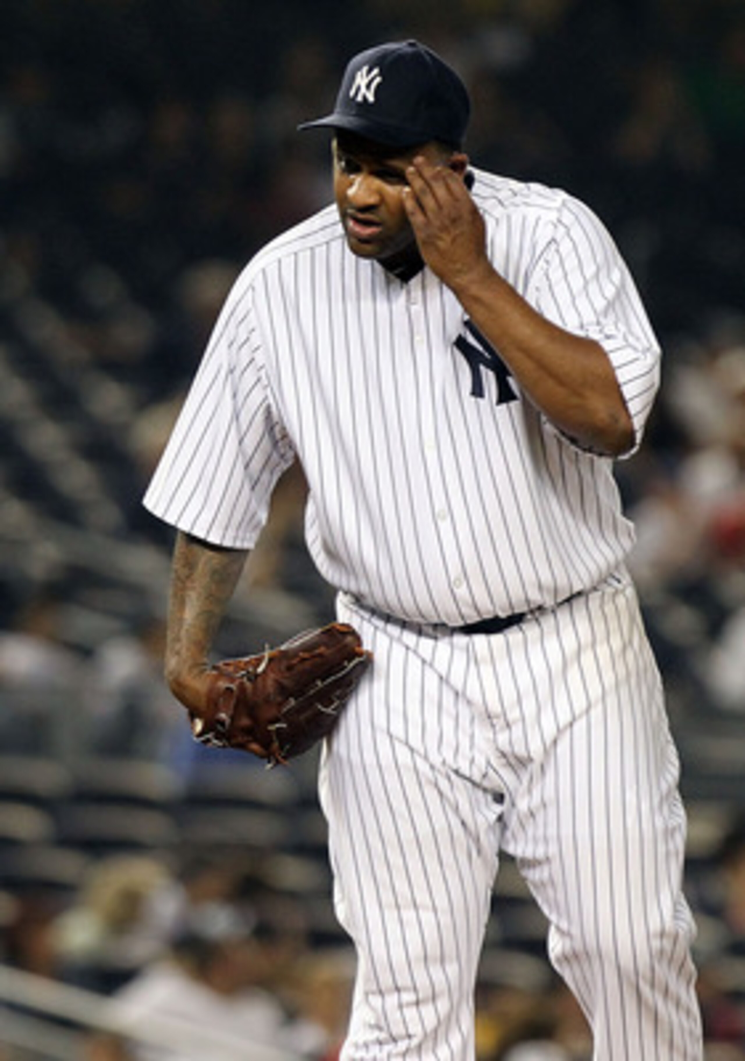 NEW YORK, NY - JUNE 09:  CC Sabathia #52 of the New York Yankees wipes sweat from his face in the seventh inning against the Boston Red Sox on June 9, 2011 at Yankee Stadium in the Bronx borough of New York City.  (Photo by Nick Laham/Getty Images)