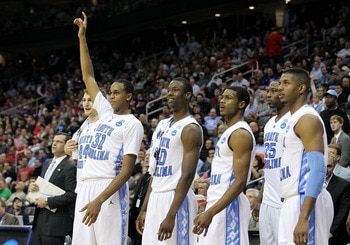 NEWARK, NJ - MARCH 25:  John Henson #31 of the North Carolina Tar Heels points to the sky on bench to celebrate the defeat of the Marquette Golden Eagles during the east regional semifinal of the 2011 NCAA Men's Basketball Tournament at the Prudential Cen