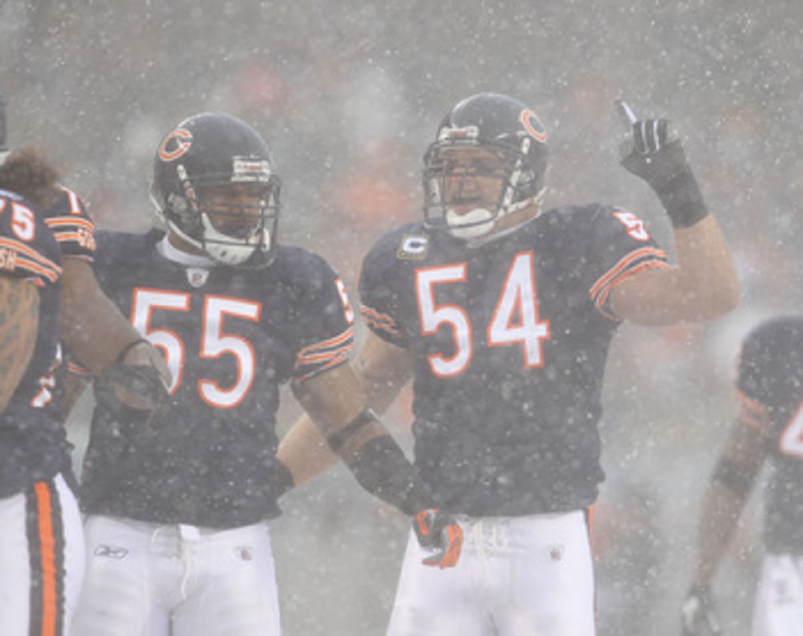 CHICAGO, IL - DECEMBER 12: Brian Urlacher #54 of the Chicago Bears calls a defensive play as teammate Lance Briggs #55 moves into position against the New England Patriots at Soldier Field on December 12, 2010 in Chicago, Illinois. The Patriots defeated t