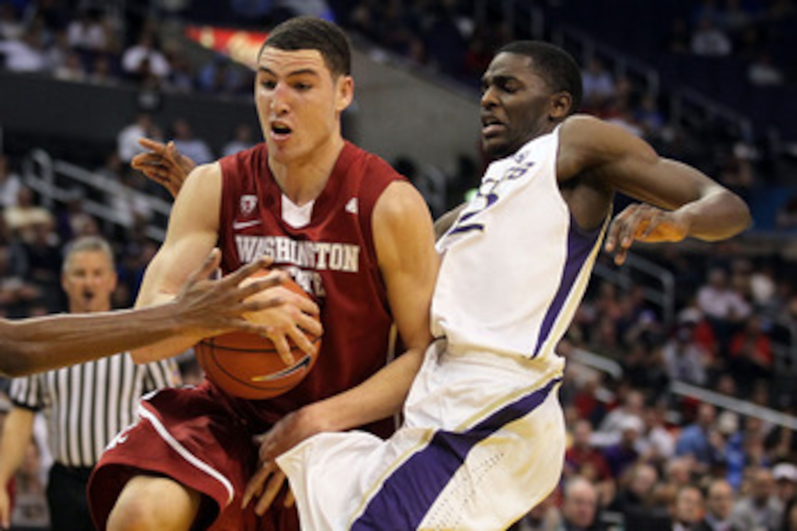 LOS ANGELES, CA - MARCH 10:  Klay Thompson #1 of the Washington State Cougars drives against Justin Holiday #22 of the Washington Huskies in the first half in the quarterfinals of the 2011 Pacific Life Pac-10 Men's Basketball Tournament at Staples Center