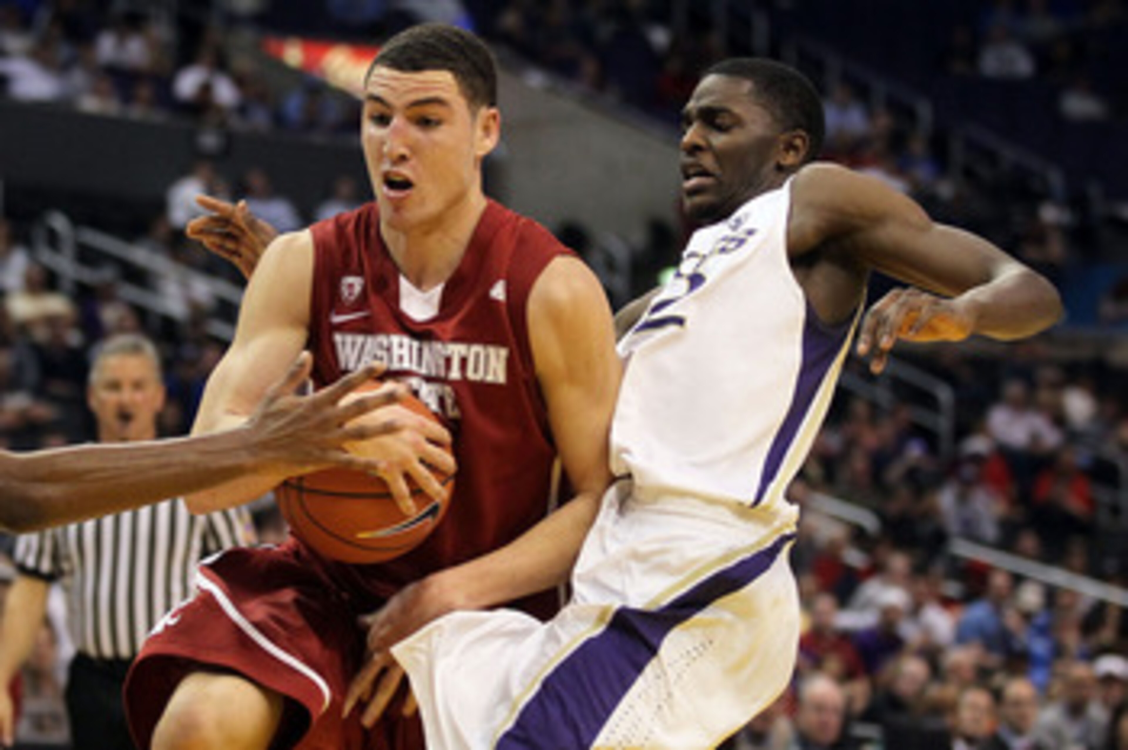 LOS ANGELES, CA - MARCH 10:  Klay Thompson #1 of the Washington State Cougars drives against Justin Holiday #22 of the Washington Huskies in the first half in the quarterfinals of the 2011 Pacific Life Pac-10 Men's Basketball Tournament at Staples Center