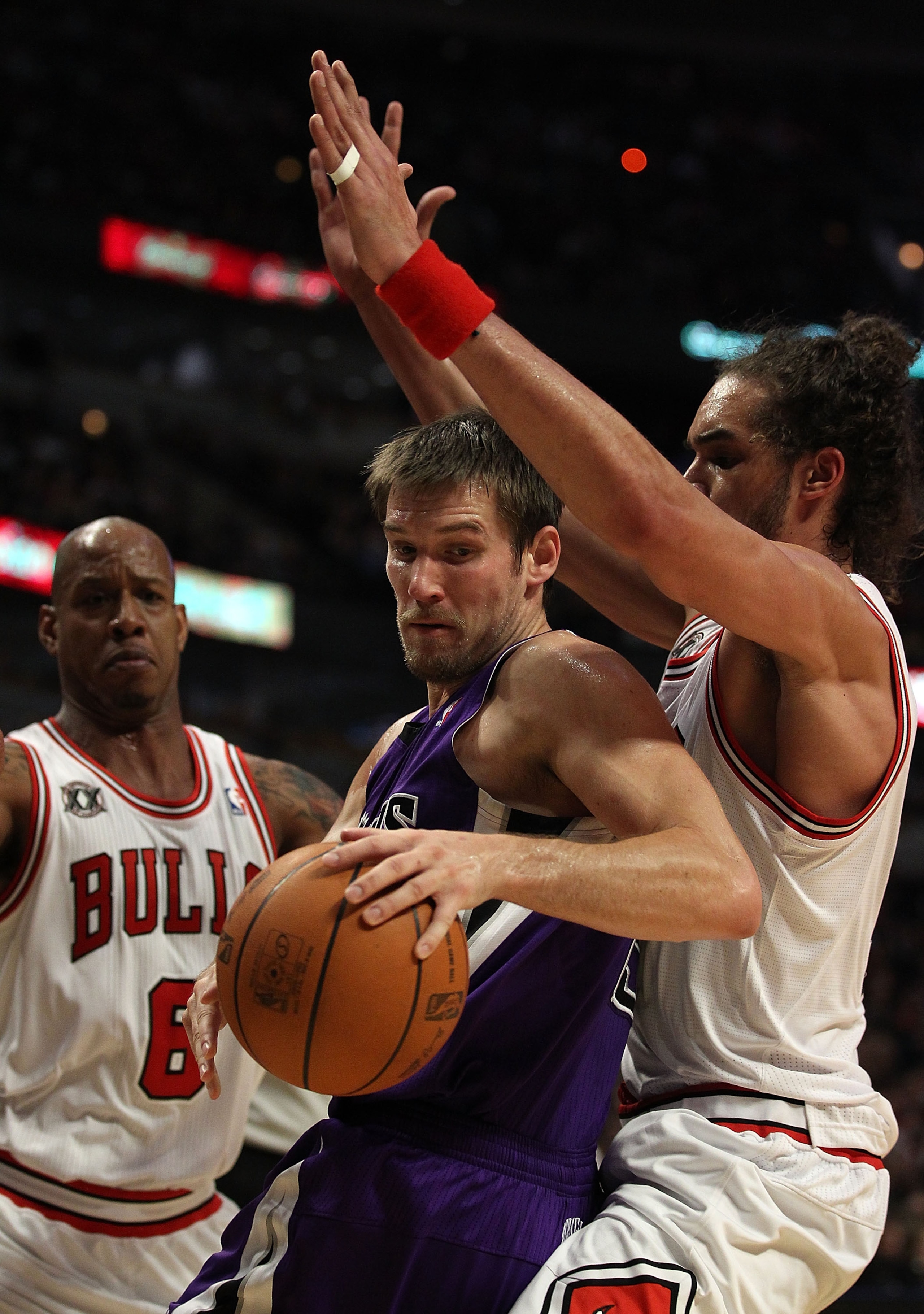 CHICAGO, IL - MARCH 21: Beno Udrih #19 of the Sacramento Kings tries to move under pressure from Joakim Noah #13 and Keith Bogans #6 of the Chicago Bulls at the United Center on March 21, 2011 in Chicago, Illinois. The Bulls defeated the Kings 132-92. NOT