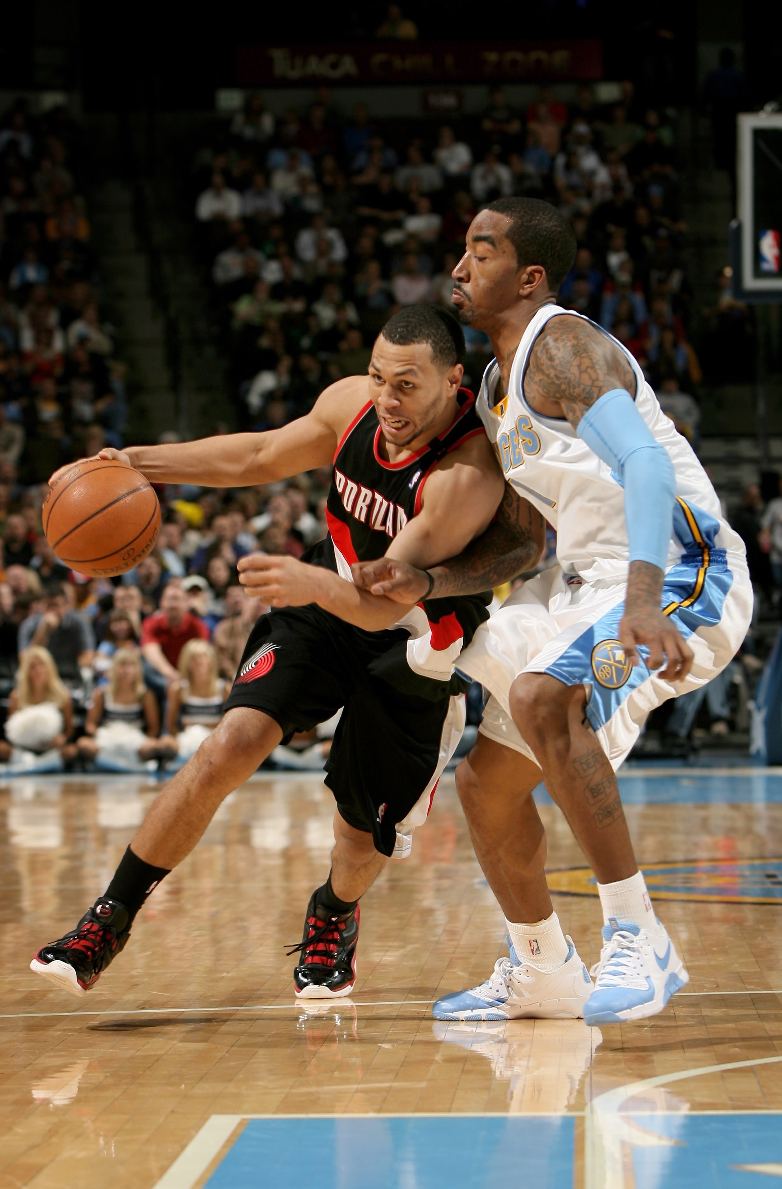 DENVER - MARCH 05:  Brandon Roy #7 of the Portland Trail Blazers drives past J.R. Smith #1 of the Denver Nuggets during NBA action at the Pepsi Center on March 5, 2009 in Denver, Colorado. The Nuggets defeated the Trail Blazers 106-90. NOTE TO USER: User