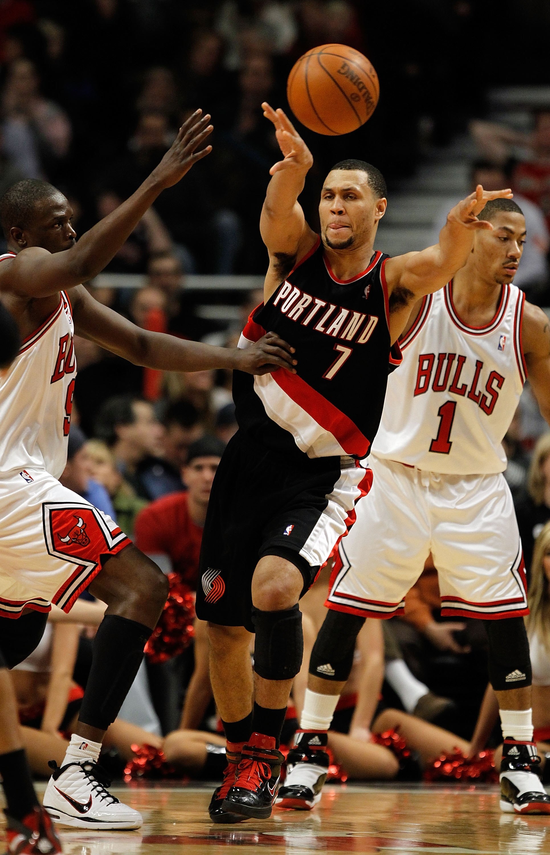 CHICAGO - FEBRUARY 26: Brandon Roy #7 of the Portland Trail Blazers passes the ball under pressure from Loul Deng #9 and Derrick Rose #1 of the Chicago Bulls at the United Center on February 26, 2010 in Chicago, Illinois. The Bulls defeated the Trail Blaz