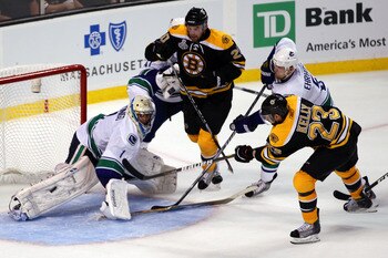 BOSTON, MA - JUNE 06:  Chris Kelly #23 of the Boston Bruins scores a goal in the third period against Roberto Luongo #1 of the Vancouver Canucks during Game Three of the 2011 NHL Stanley Cup Final at TD Garden on June 6, 2011 in Boston, Massachusetts.  (P