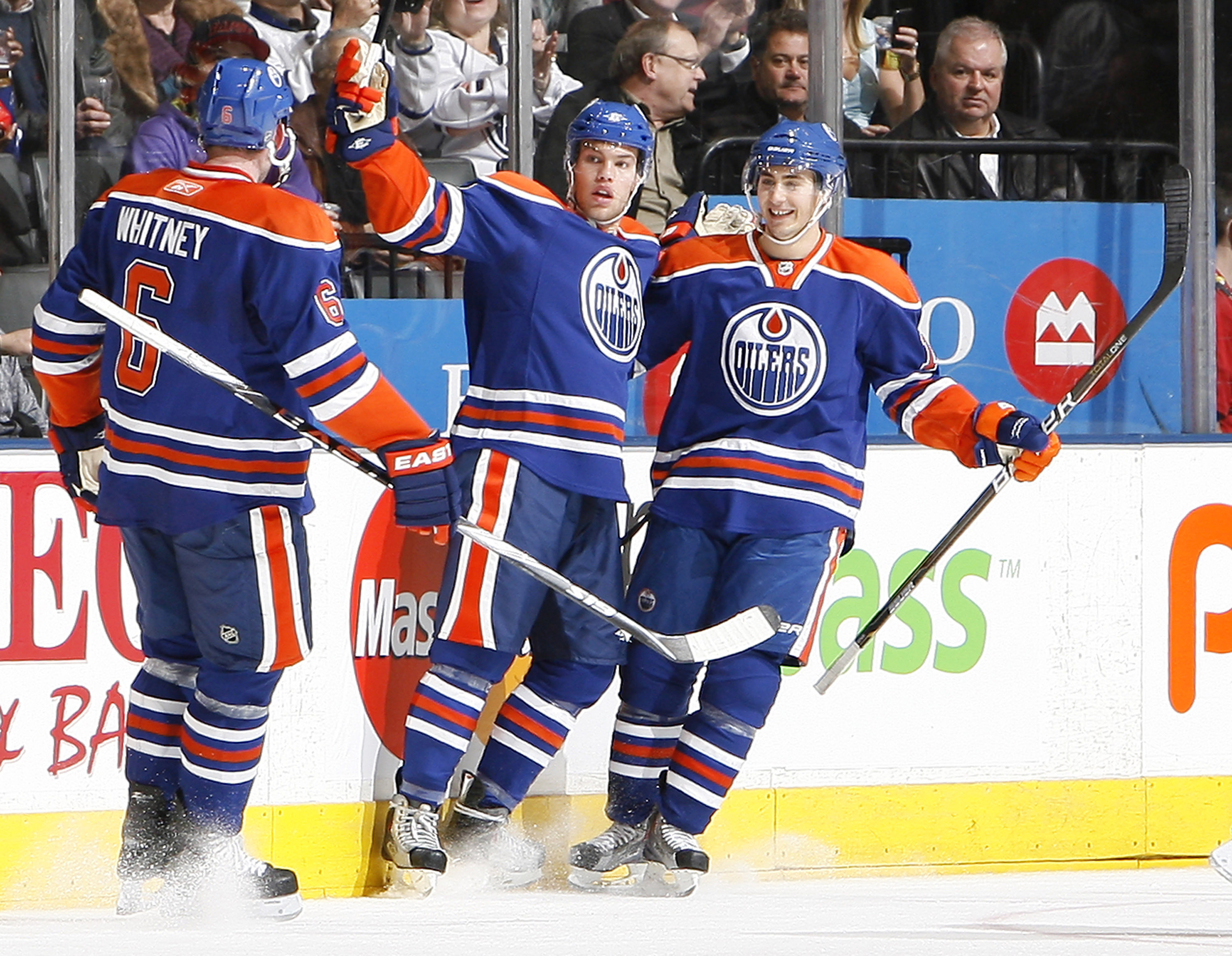 TORONTO, CANADA - DECEMBER 2: Ryan Whitney #6, Taylor Hall #4 and Jordan Eberle #14 of the Edmonton Oilers celebrate goal during game action against the New Jersey Devils at the Air Canada Centre December 2, 2010 in Toronto, Ontario, Canada. (Photo by Abe