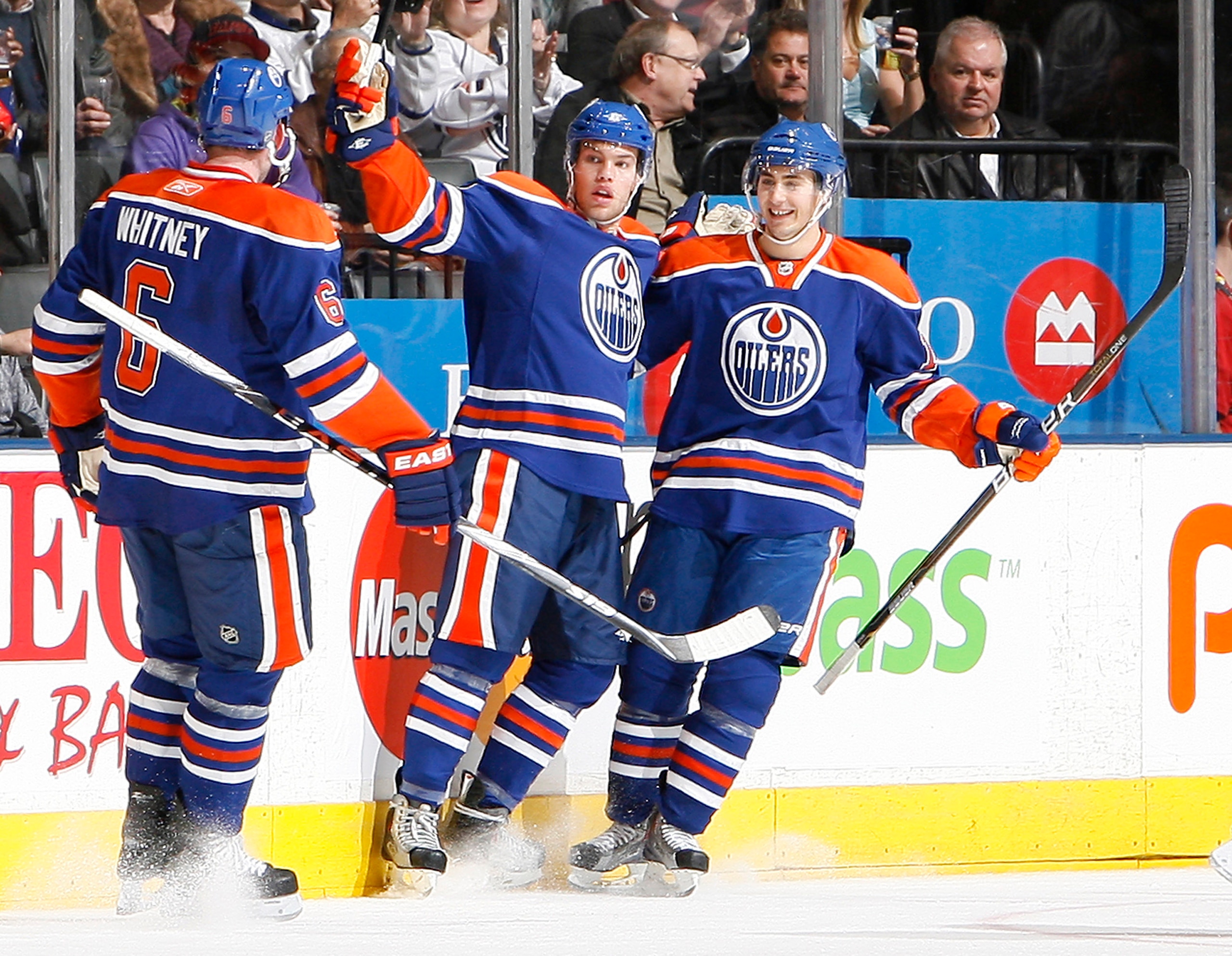 TORONTO, CANADA - DECEMBER 2: Ryan Whitney #6, Taylor Hall #4 and Jordan Eberle #14 of the Edmonton Oilers celebrate goal during game action against the New Jersey Devils at the Air Canada Centre December 2, 2010 in Toronto, Ontario, Canada. (Photo by Abe