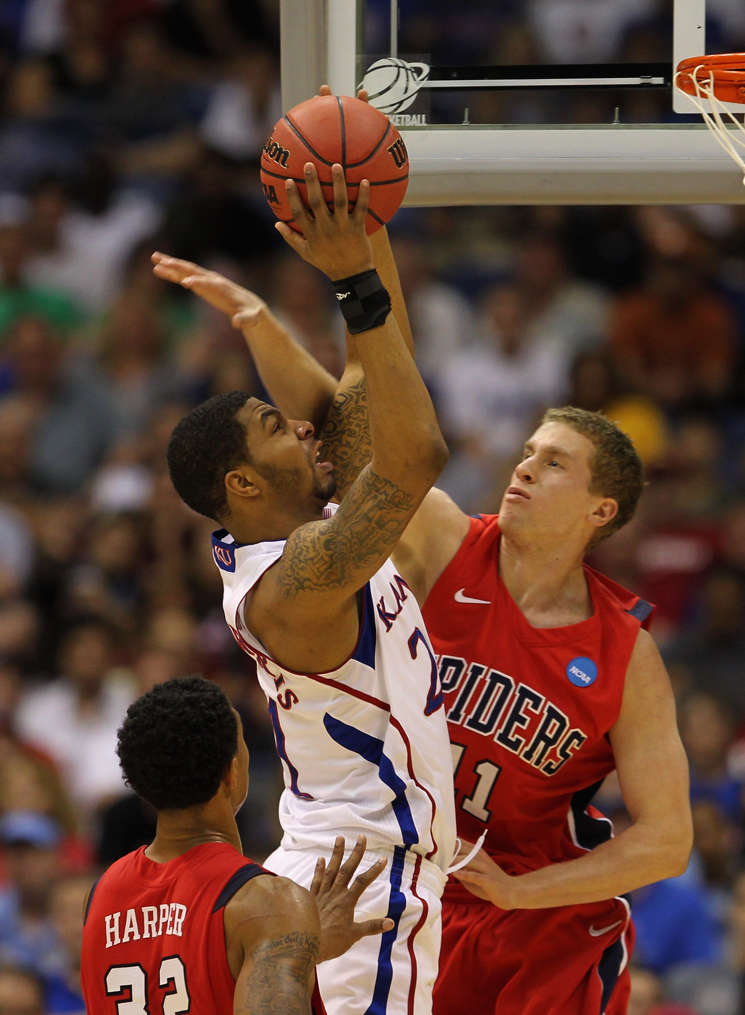 SAN ANTONIO, TX - MARCH 25:  Markieff Morris #21 of the Kansas Jayhawks goes to the basket against Josh Duinker #11 of the Richmond Spiders during the southwest regional of the 2011 NCAA men's basketball tournament at the Alamodome on March 25, 2011 in Sa