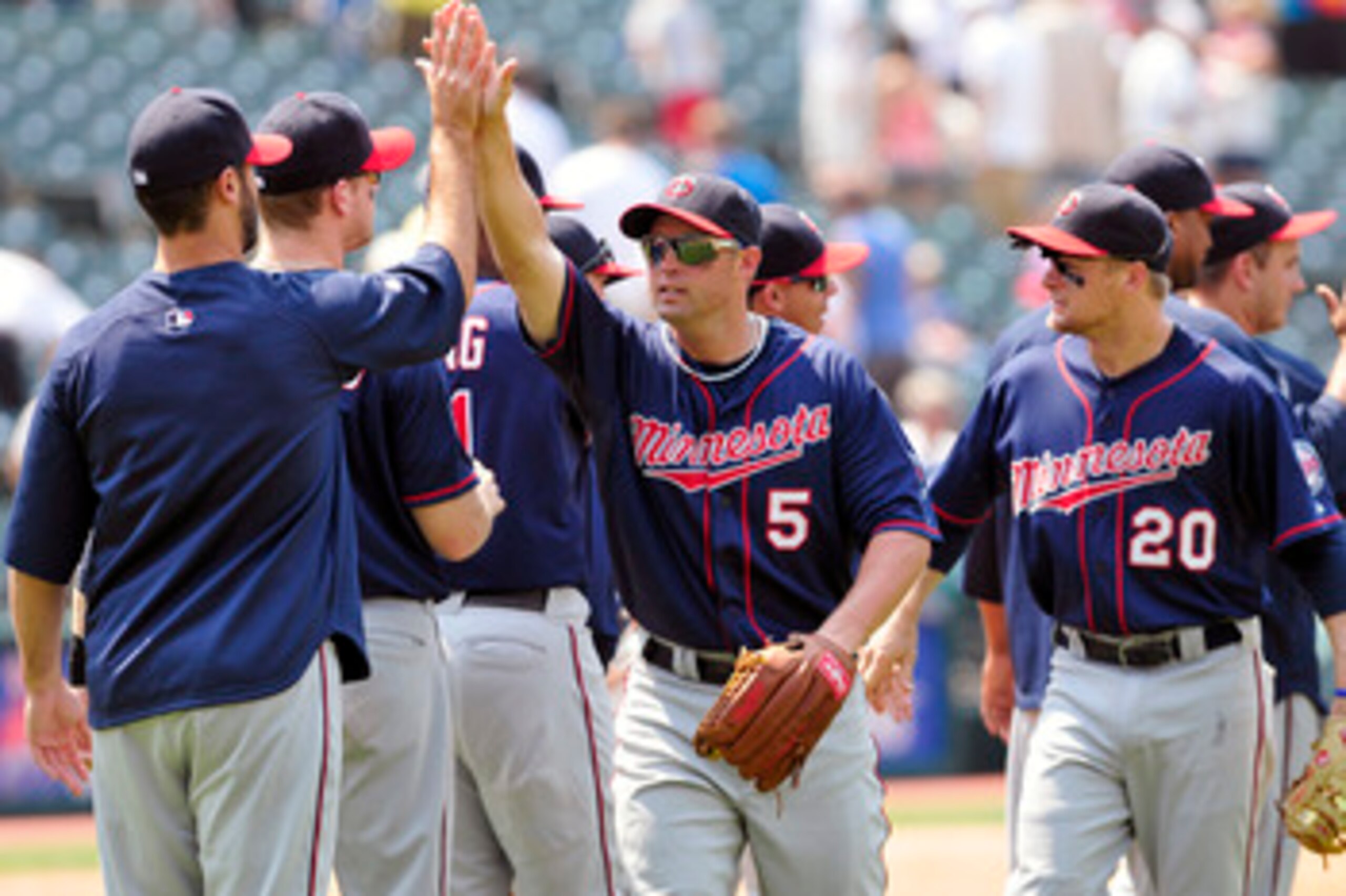 CLEVELAND, OH - JUNE 8: Michael Cuddyer #5 and Matt Tolbert #20 of the Minnesota Twins celebrate with teammates after defeating the Indians 3-2 in extra innings at Progressive Field on June 8, 2011 in Cleveland, Ohio. (Photo by Jason Miller/Getty Images) CLEVELAND, OH - JUNE 8: Michael Cuddyer #5 and Matt Tolbert #20 of the Minnesota Twins celebrate with teammates after defeating the Indians 3-2 in extra innings at Progressive Field on June 8, 2011 in Cleveland, Ohio. (Photo by Jason Miller/Getty Images)