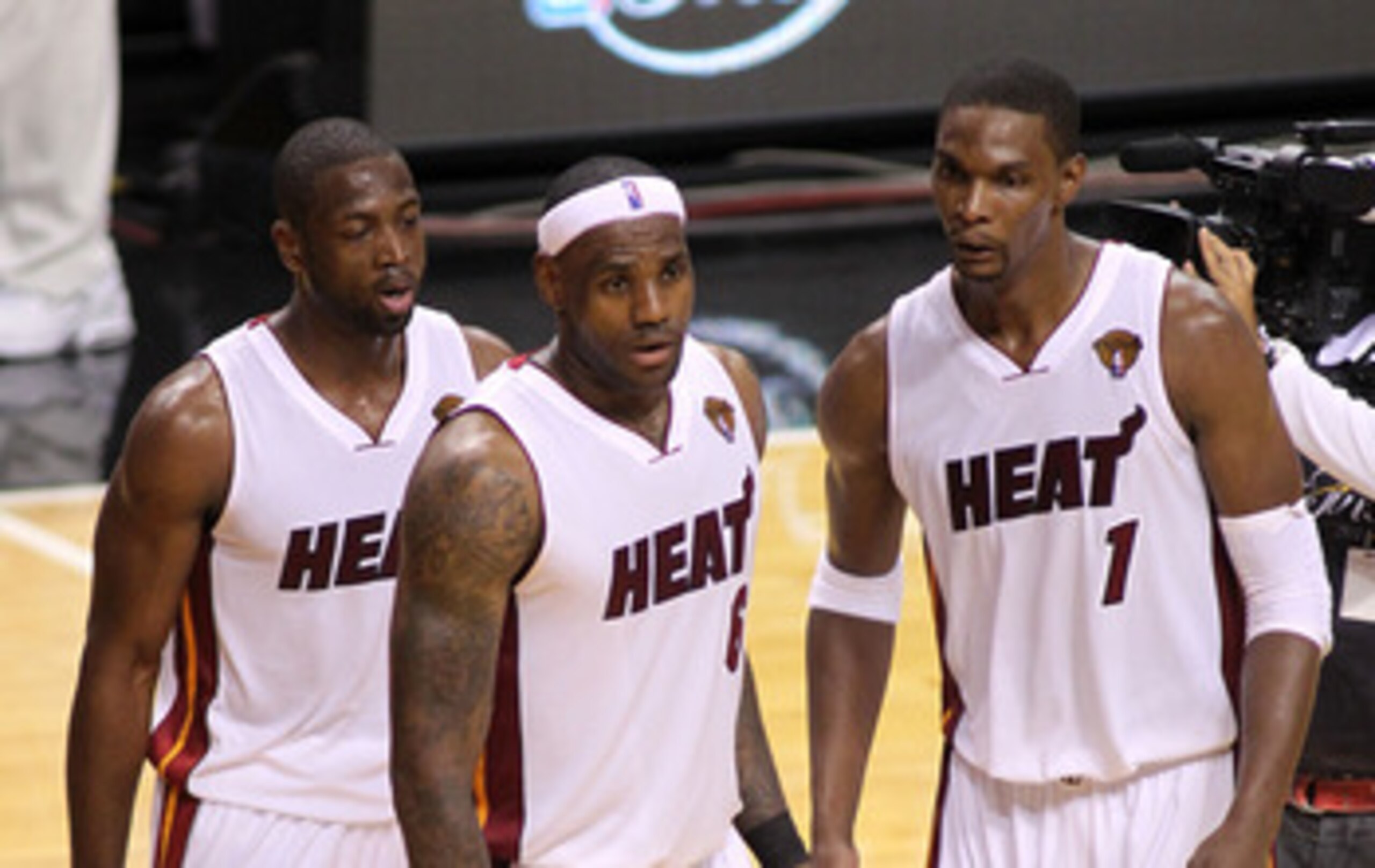 DALLAS - NOVEMBER 27: Chris Bosh #1, 2 #6 and Dwyane Wade #3 of the Miami Heat look on during their game against the Dallas Mavericks  on November 27, 2010 at the American Airlines Center in Dallas, Texas. NOTE TO USER: User expressly acknowledges and agr