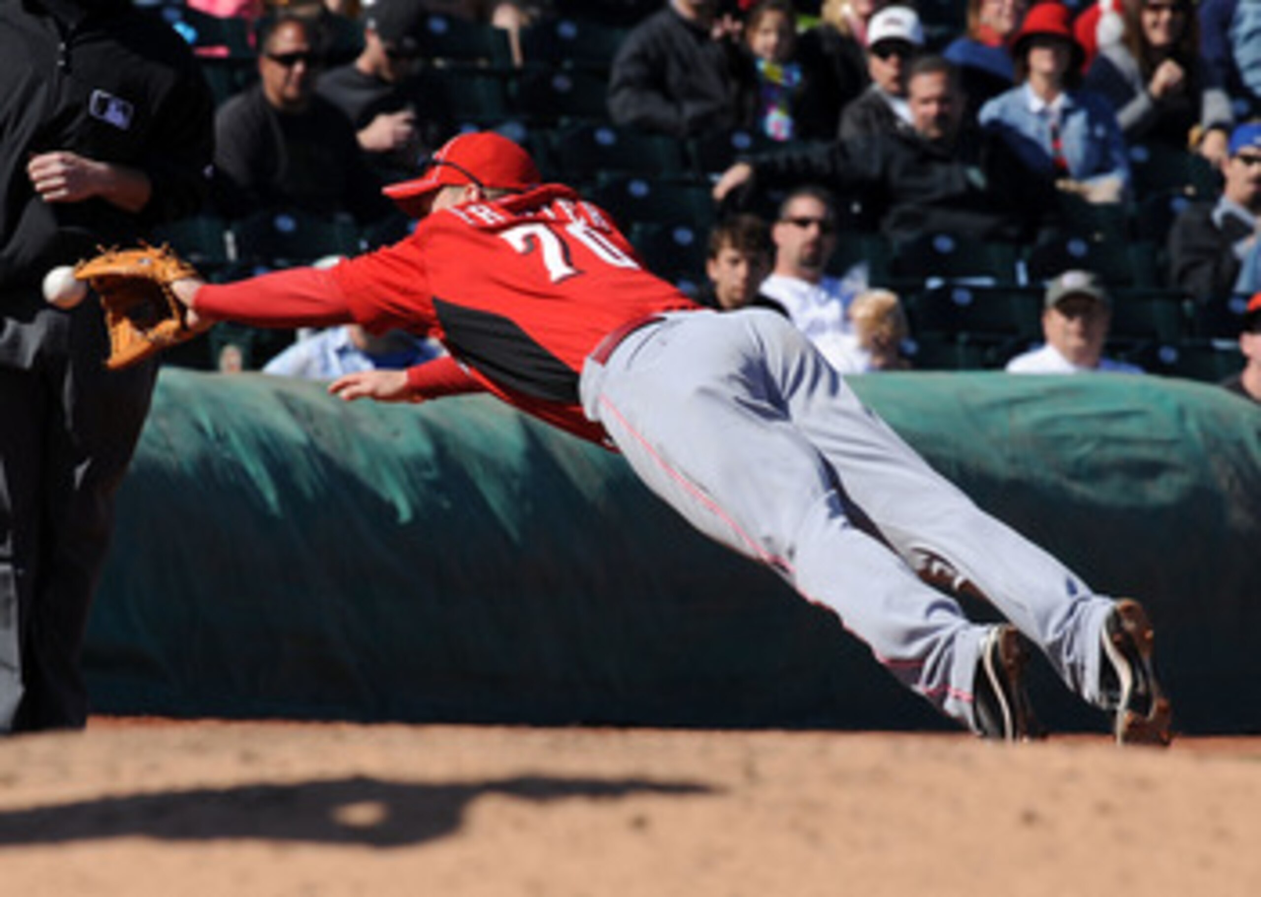 GOODYEAR, AZ - FEBRUARY 27:  Todd Frazier #70 of the Cincinnati Reds dives for a ground ball against the Cleveland Indians at Goodyear Ballpark on February 27, 2011 in Goodyear, Arizona.  (Photo by Norm Hall/Getty Images)