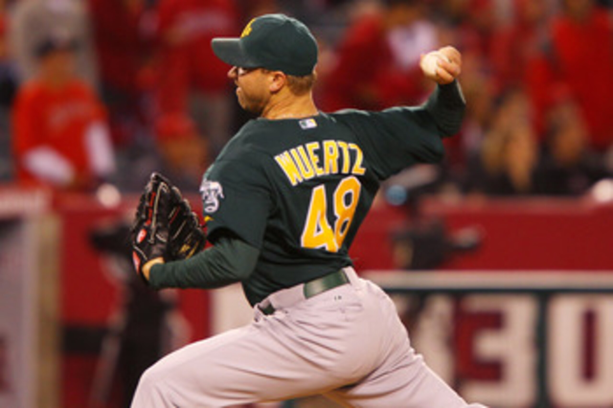 ANAHEIM, CA - MAY 23:  Michael Wuertz #48 of the Oakland Athletics pitches in the eighth inning during the game against the Los Angeles Angels of Anaheim at Angel Stadium on May 23, 2011 in Anaheim, California.  (Photo by Joe Scarnici/Getty Images)
