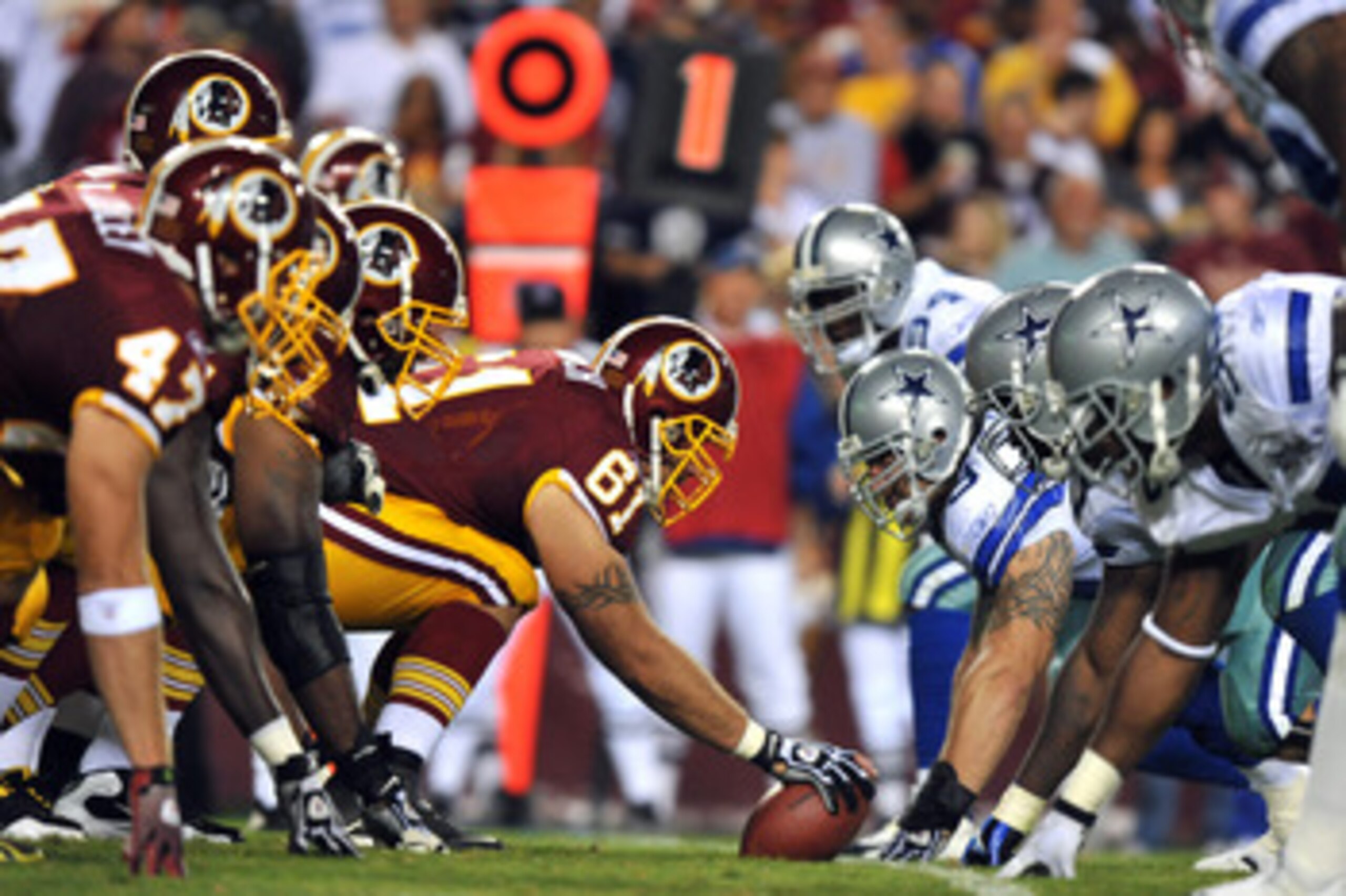 LANDOVER - SEPTEMBER 12:  Casey Rabach #61 of the Washington Redskins snaps the ball during the NFL season opener against the Dallas Cowboys at FedExField on September 12, 2010 in Landover, Maryland. The Redskins defeated the Cowboys 13-7. (Photo by Larry