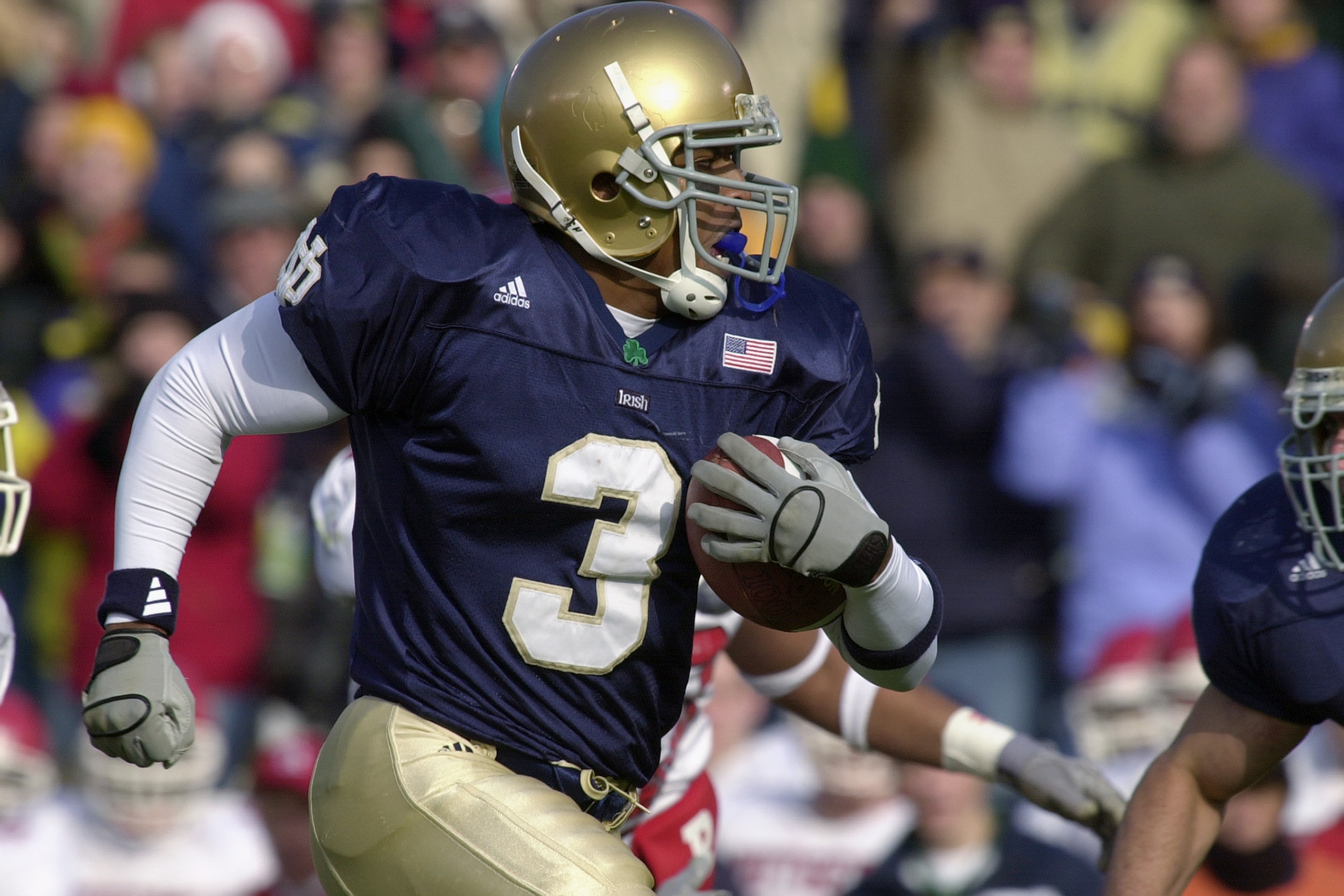 SOUTH BEND, IN - NOVEMBER 23: Running back Arnaz Battle #3 of the University of Notre Dame Fighting Irish carries the ball against Rutgers, The State University of New Jersey, Scarlet Knights during the game at Notre Dame Stadium on November 23, 2002 in SOUTH BEND, IN - NOVEMBER 23: Running back Arnaz Battle #3 of the University of Notre Dame Fighting Irish carries the ball against Rutgers, The State University of New Jersey, Scarlet Knights during the game at Notre Dame Stadium on November 23, 2002 in