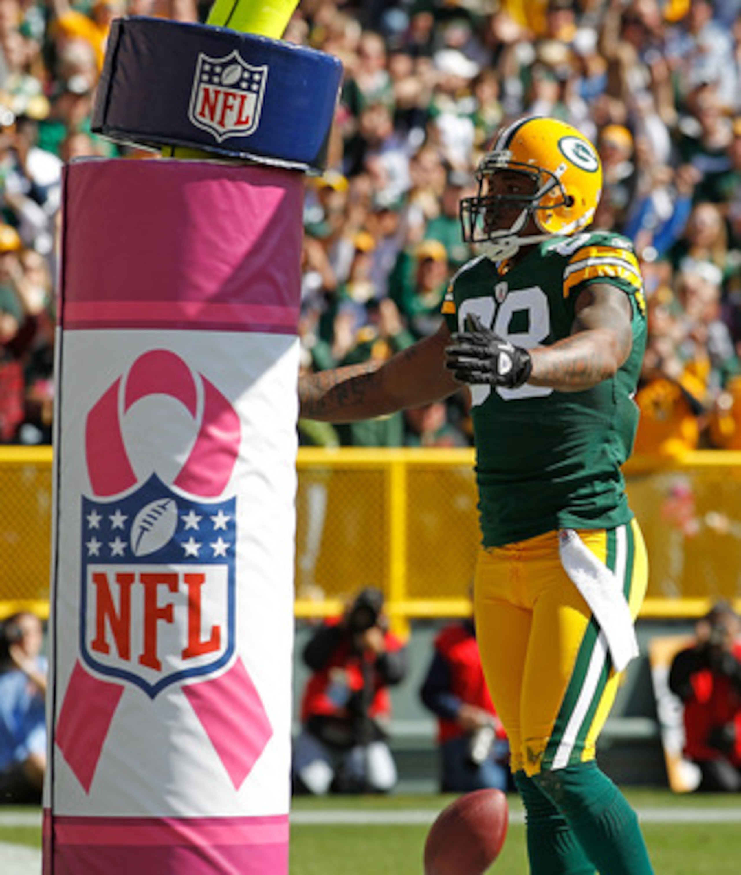 GREEN BAY, WI - OCTOBER 03: Jermichael Finley #88 of the Green Bay Packers celebrates a touchdown catch against the Detroit Lions in front of a goal post wrapped with a breast cancer awarness pad at Lambeau Field on October 3, 2010 in Green Bay, Wisconsin