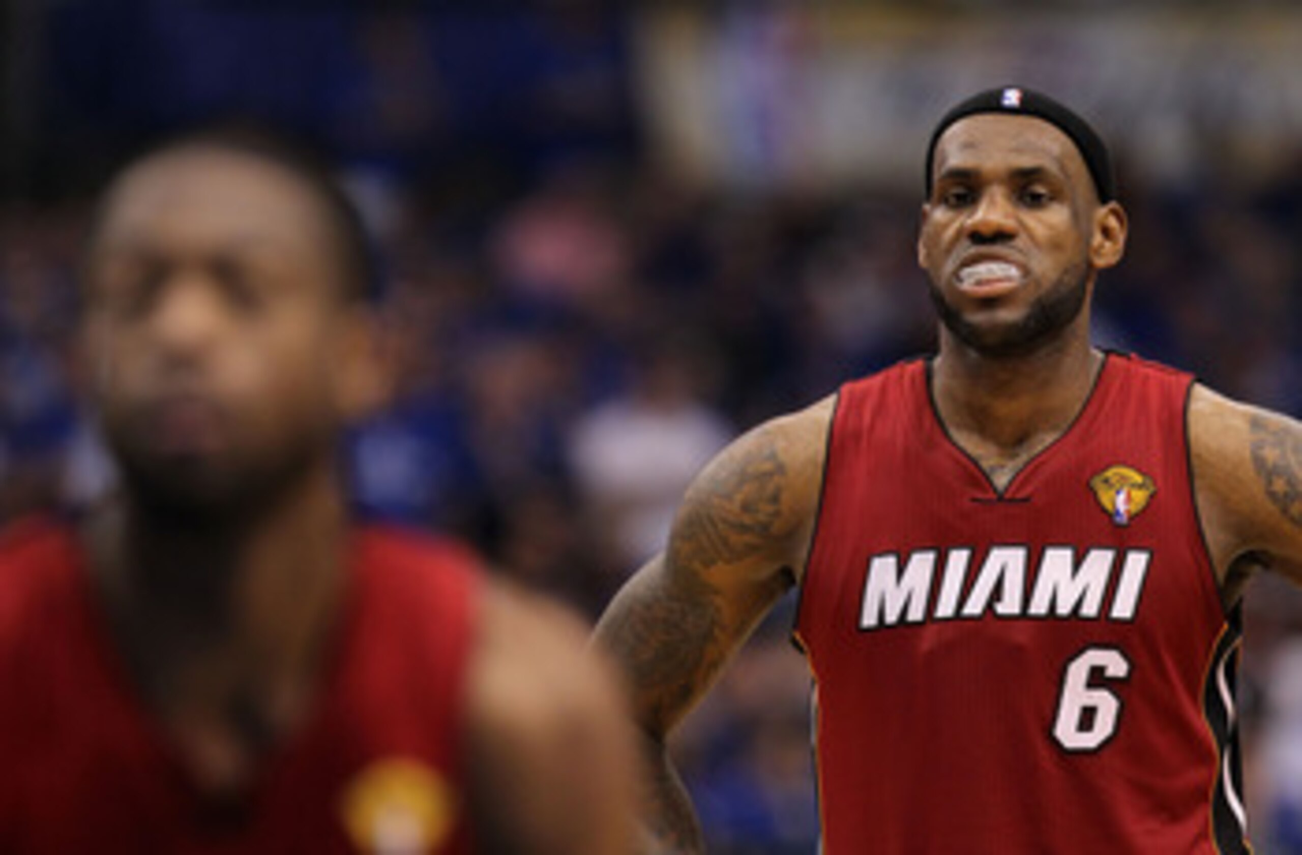 DALLAS, TX - JUNE 07:  LeBron James #6 of the Miami Heat looks on while teammate Dwyane Wade #3 shoots a free throw while taking on the Dallas Mavericks in Game Four of the 2011 NBA Finals at American Airlines Center on June 7, 2011 in Dallas, Texas. NOTE