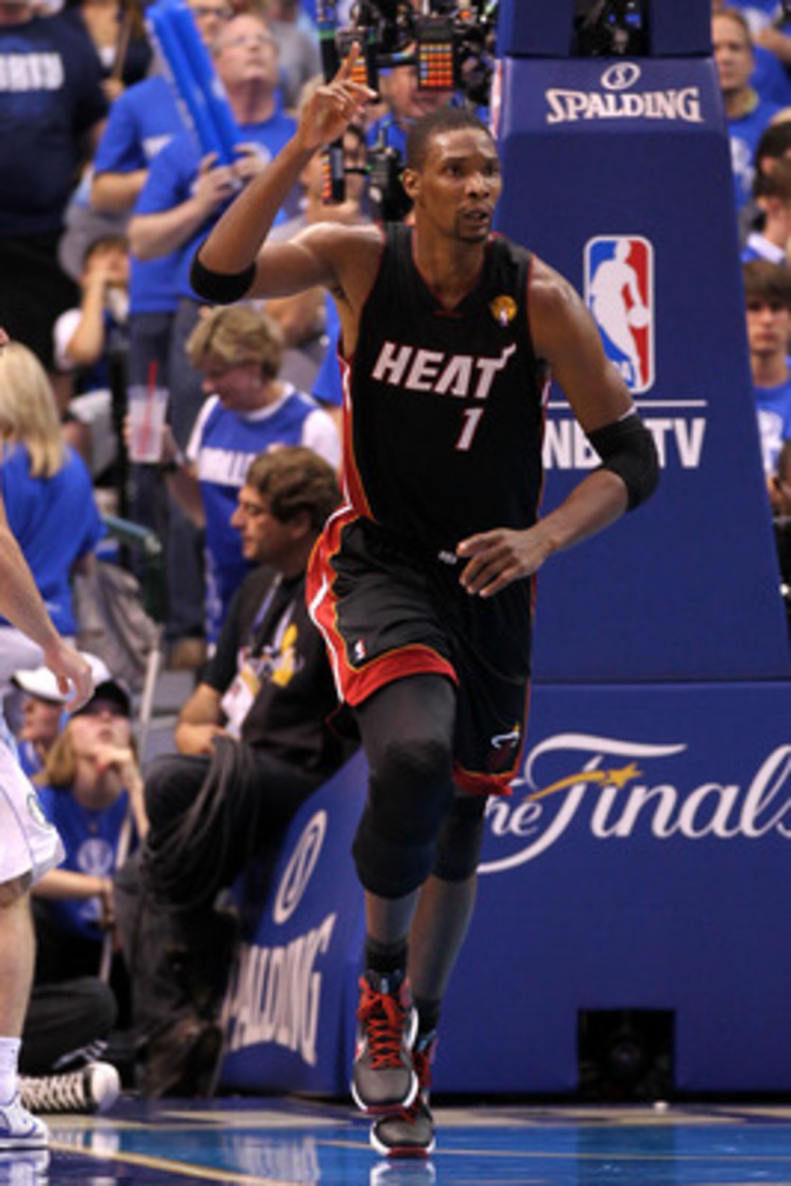 DALLAS, TX - JUNE 09:  Chris Bosh #1 of the Miami Heat reacts as he runs up court against the Dallas Mavericks in Game Five of the 2011 NBA Finals at American Airlines Center on June 9, 2011 in Dallas, Texas.  NOTE TO USER: User expressly acknowledges and