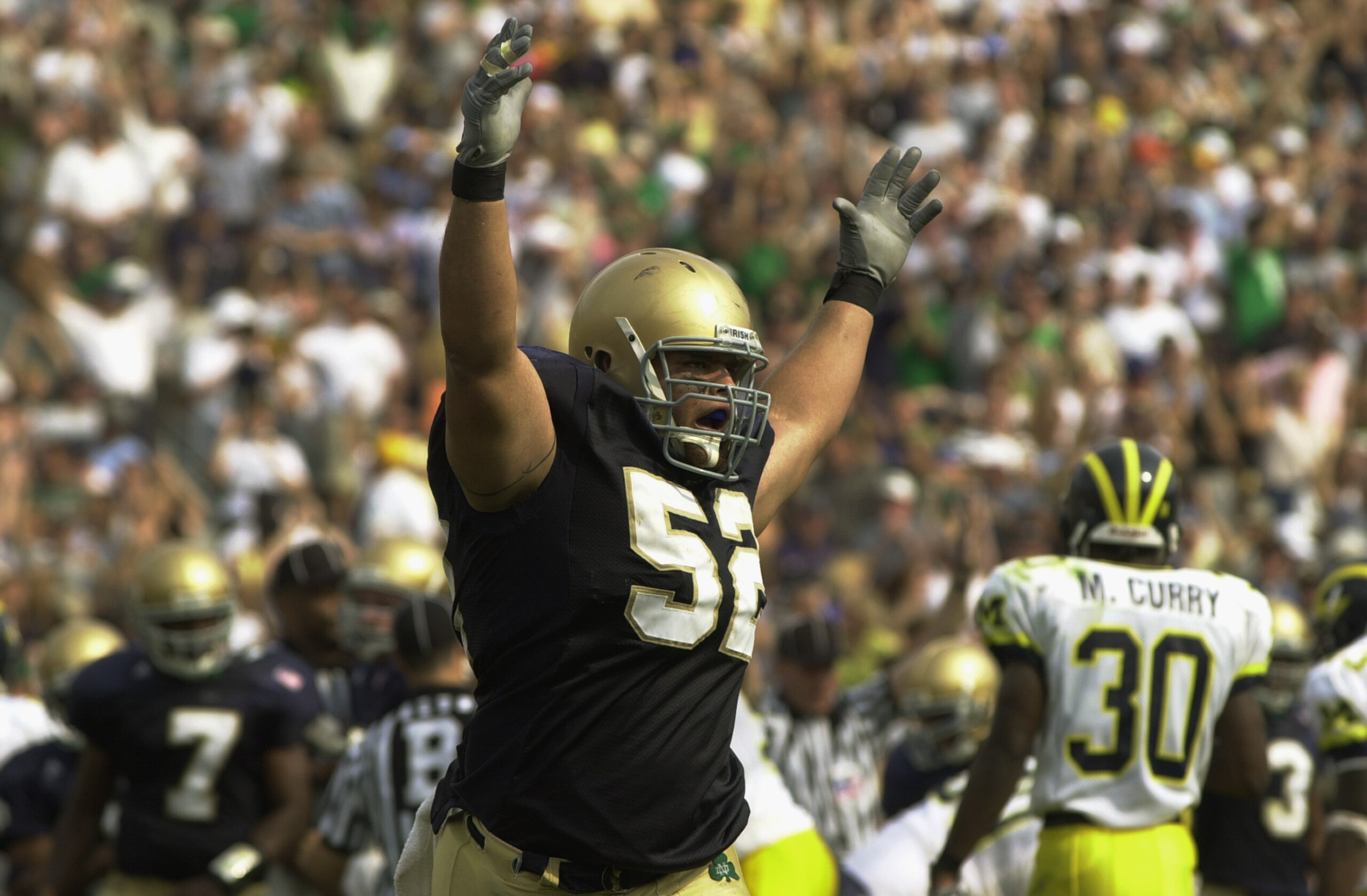 SOUTH BEND, IN - SEPTEMBER 14: Center Jeff Faine #52 of Notre Dame celebrates after a second quarter touchdown by quarterback Carlyle Holiday during the NCAA football game against Michigan at Notre Dame Stadium in South Bend, Indiana on September 14, 200 SOUTH BEND, IN - SEPTEMBER 14: Center Jeff Faine #52 of Notre Dame celebrates after a second quarter touchdown by quarterback Carlyle Holiday during the NCAA football game against Michigan at Notre Dame Stadium in South Bend, Indiana on September 14, 200