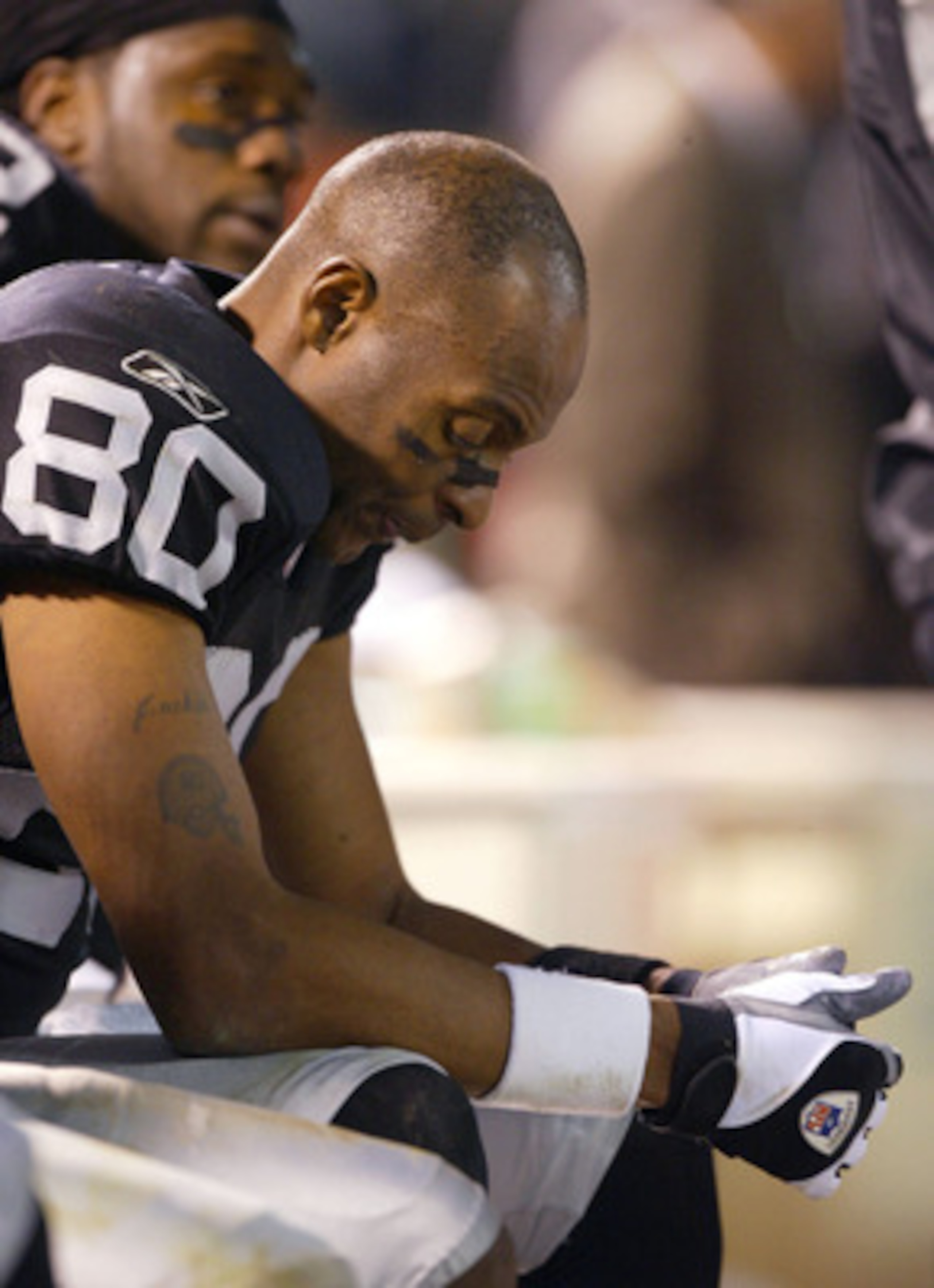 OAKLAND, CA - DECEMBER 22:  Jerry Rice #80 of the Oakland Raiders sits on the bench against the Green Bay Packers during an NFL game on December 22, 2003  at the Network Associates Coliseum in Oakland, California.  (Photo by Jed Jacobsohn/Getty Images)