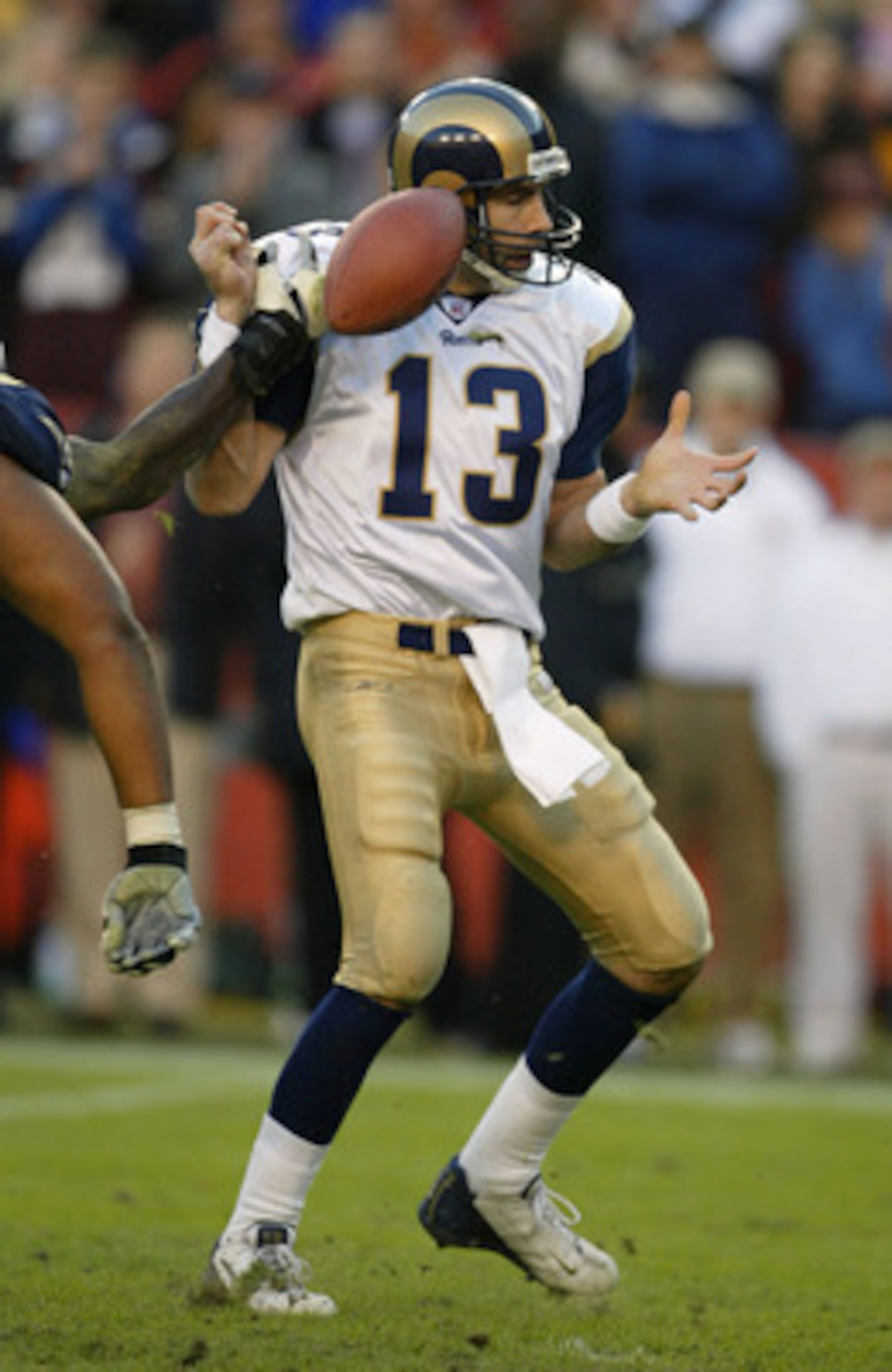 LANDOVER, MD - NOVEMBER 24:  Quarterback Kurt Warner #13 of the St. Louis Rams fumbles the ball after being hit by LaVar Arrington of the Washington Redskins as time ran out in the 4th quarter on November 24, 2002 at FedEx Field in Landover, Maryland.  Th