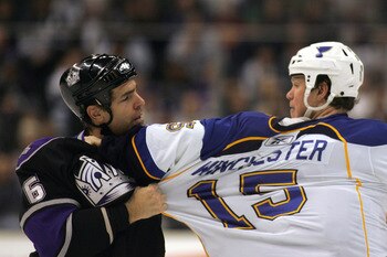 LOS ANGELES, CA - JANUARY 09:  Sean O'Donnell #6 of the Los Angeles Kings and Brad Winchester #15 of the St. Louis Blues grab one another's jersey during their third period fight in their NHL game at the Staples Center on January 9, 2010 in Los Angeles, C