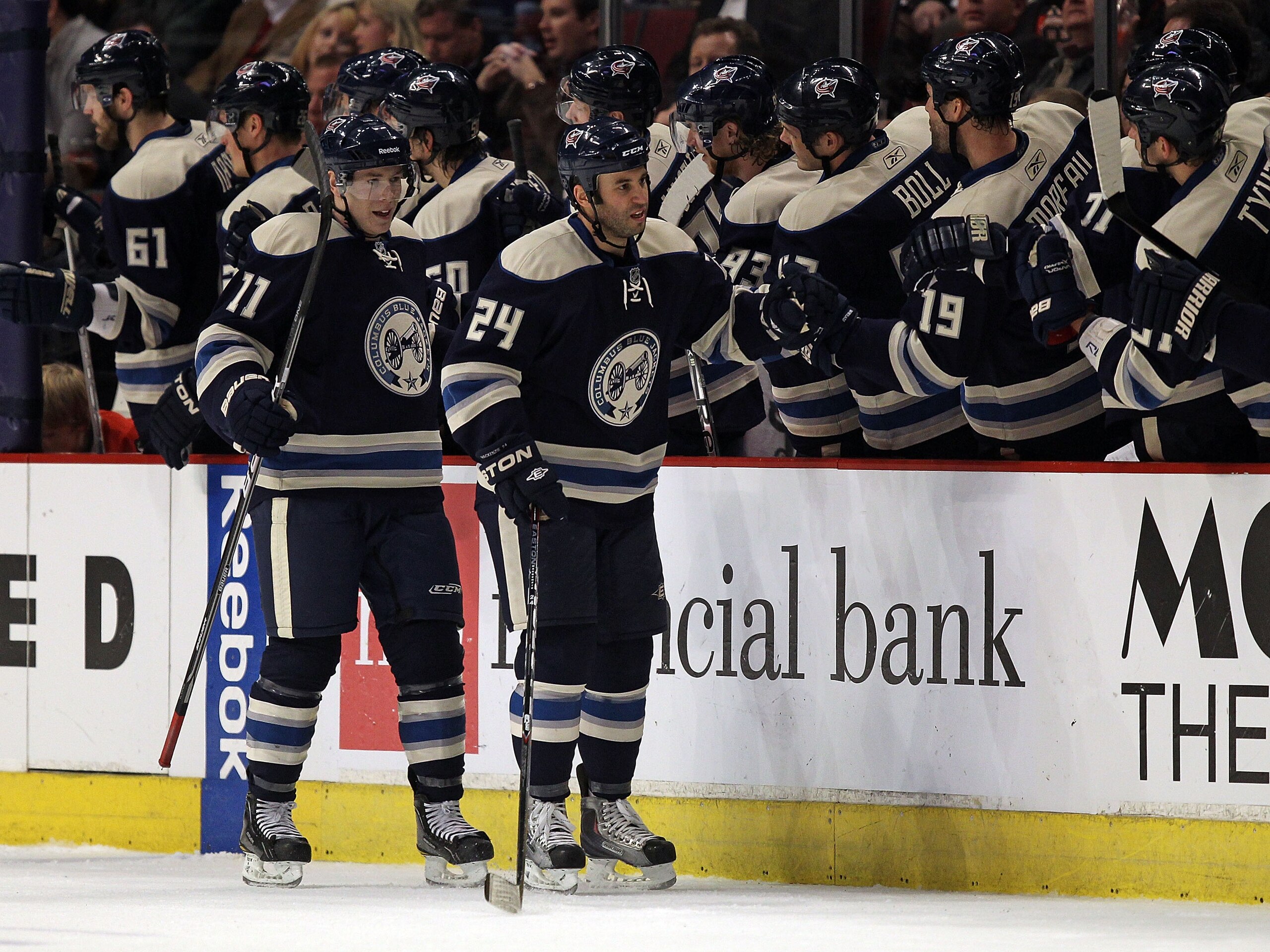 CHICAGO, IL - FEBRUARY 18: Derek ManKenzie #24 and Matt Calvert #11 of the Columbus Blue Jackets celebrate MacKenzie's 2nd period goal against the Chicago Blackhawks with teammates on the bench at the United Center on February 18, 2011 in Chicago, Illinoi