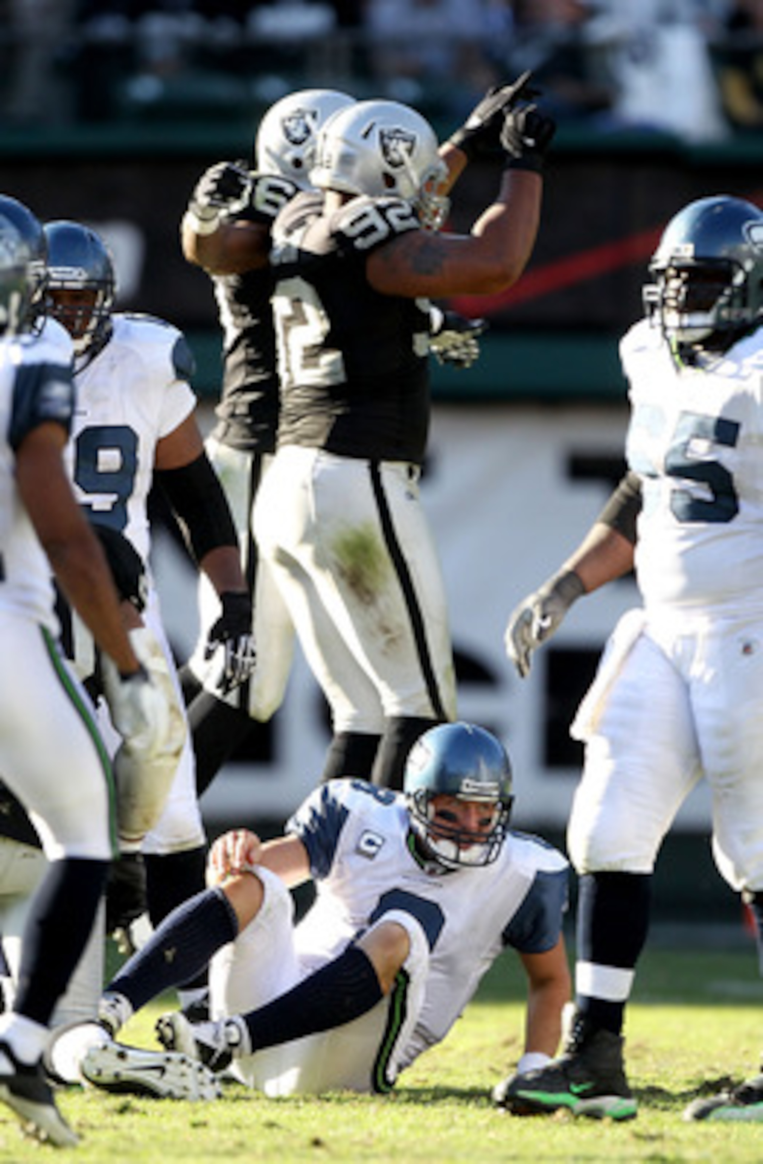 OAKLAND, CA - OCTOBER 31:  Matt Hasselbeck #8 of the Seattle Seahawks gets off the ground after he was sacked by Richard Seymour #92 of the Oakland Raiders at Oakland-Alameda County Coliseum on October 31, 2010 in Oakland, California.  (Photo by Ezra Shaw