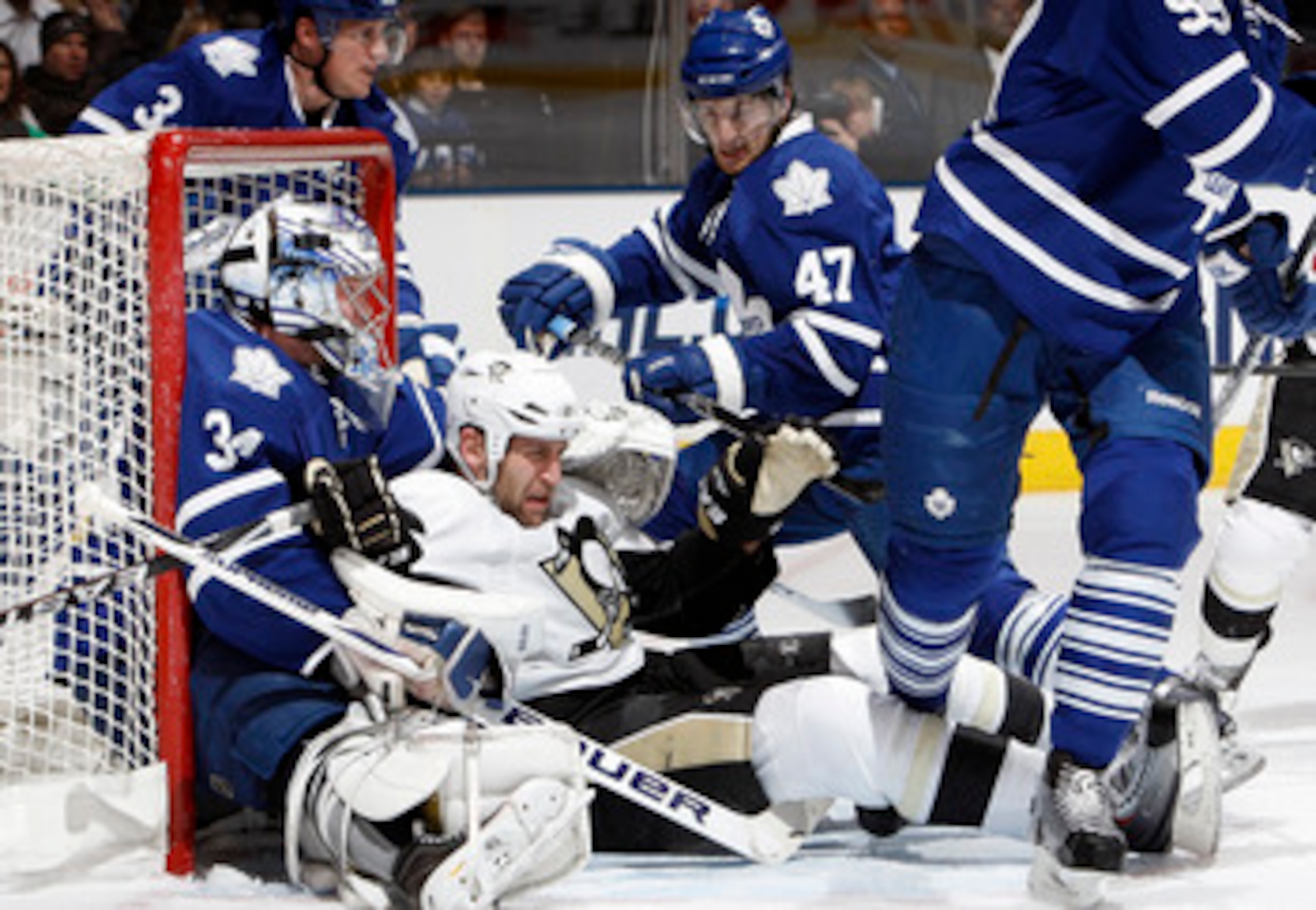TORONTO, CANADA - FEBRUARY 26: Darryl Boyce #47 of the Toronto Maple Leafs pushes Mike Rupp #17 of the Pittsburgh Penguins into James Reimer #34 of the Toronto Maple Leafs during game action at the Air Canada Centre February 26, 2011 in Toronto, Ontario, 