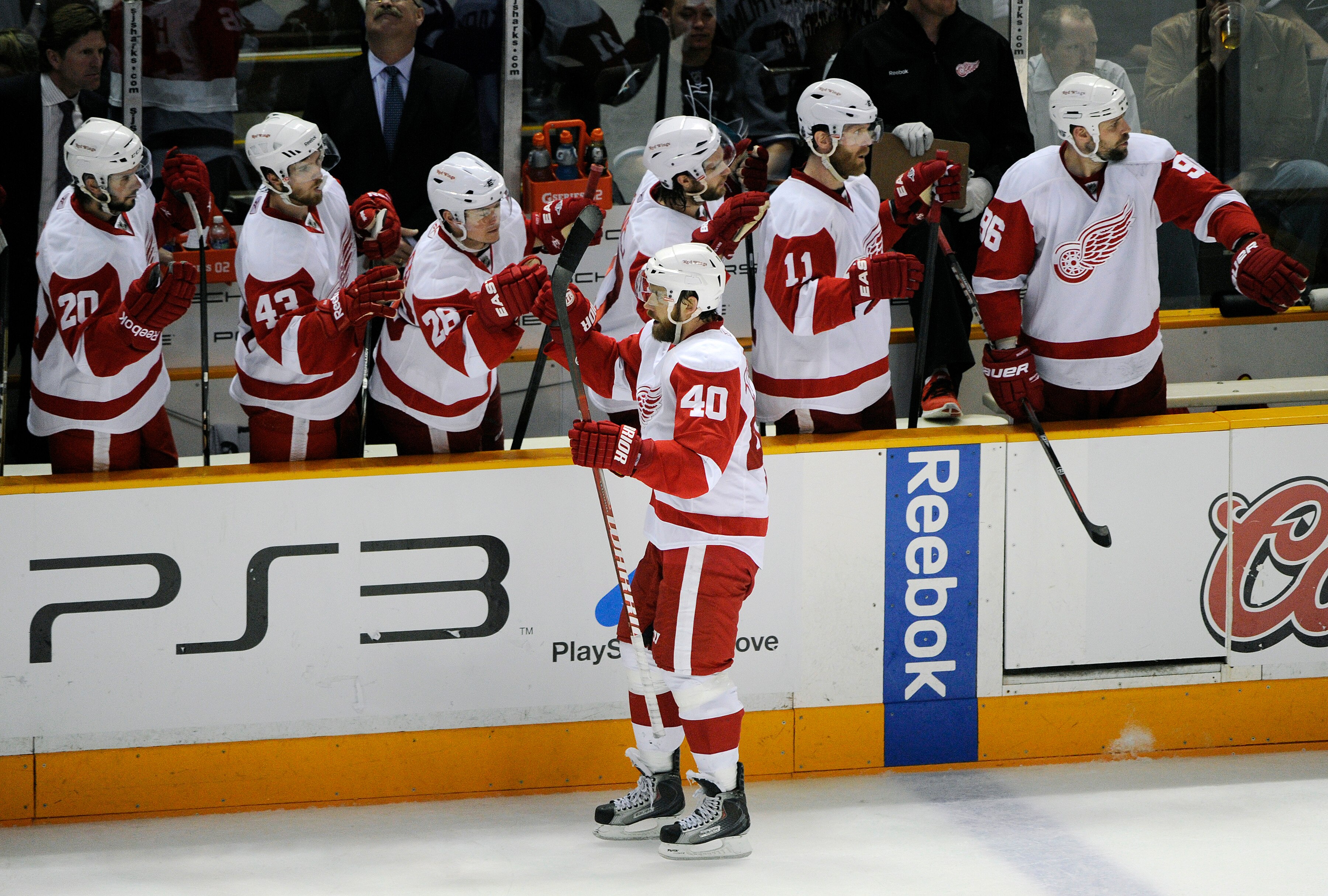SAN JOSE, CA - MAY 12: Henrik Zetterberg #40 of the Detroit Red Wings taps the gloves of teammates after scoring a goal in the second period against the San Jose Sharks in Game Seven of the Western Conference Semifinals  during the 2011 NHL Stanley Cup Pl