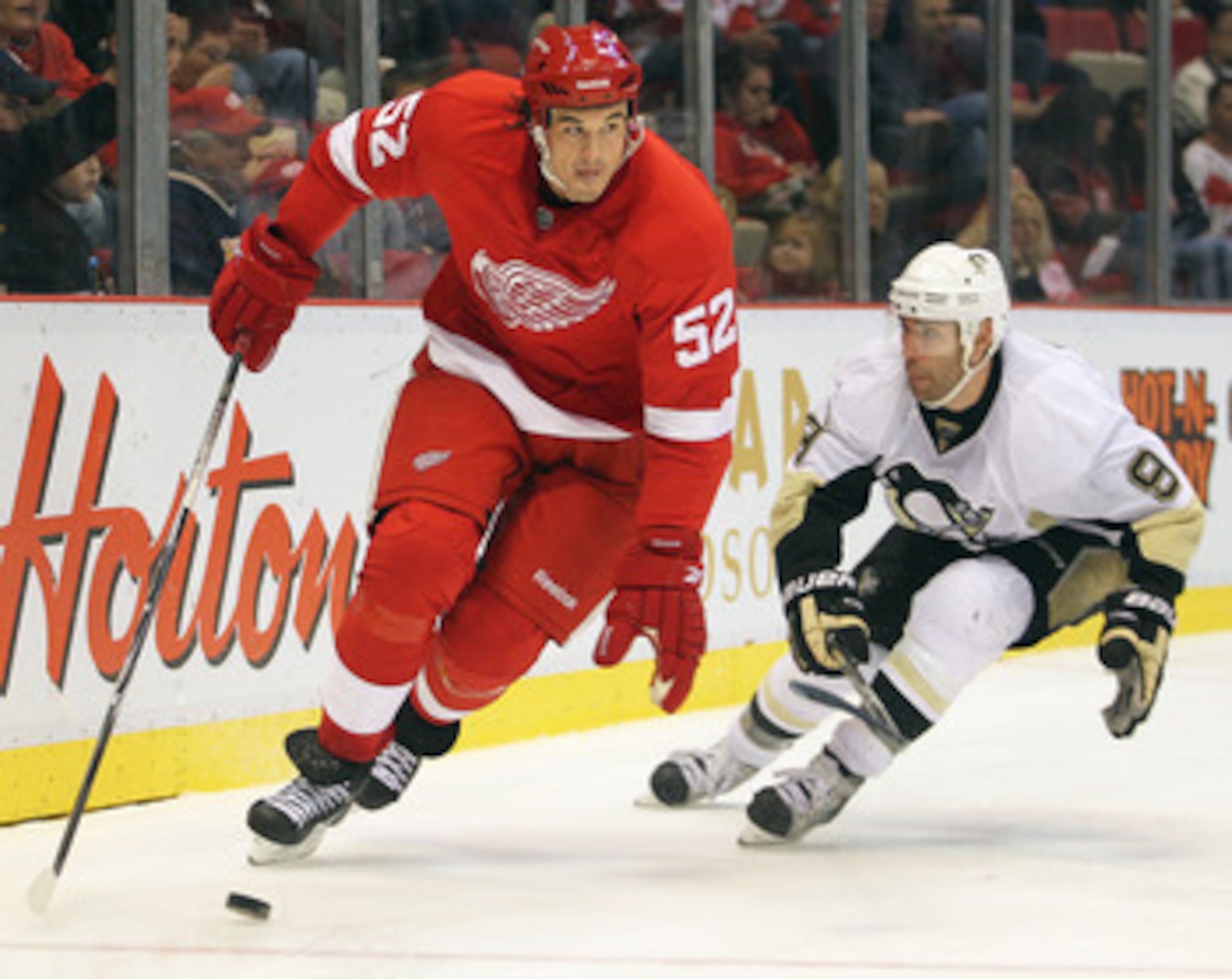 DETROIT, MI - OCTOBER 03:  Jonathan Ericsson #52 of the Detroit Red Wings skates away from a check by Pascal Dupuis #9 of the Pittsburgh Penguins in a preseason game on October 3, 2010 at the Joe Louis Arena in Detroit, Michigan. The Penguins defeated the