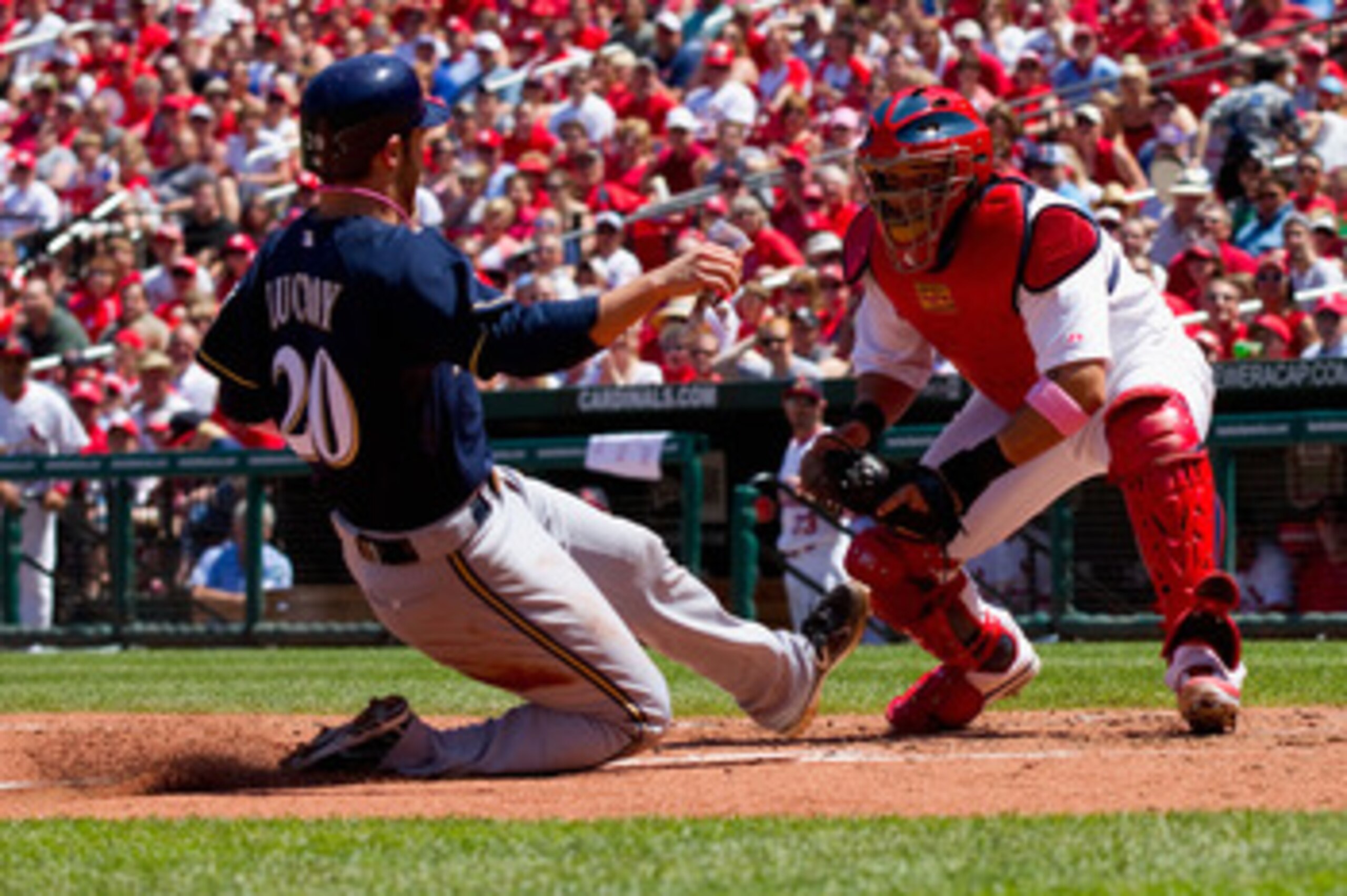 ST. LOUIS, MO - MAY 8: Jonathan Lucroy #20 of the Milwaukee Brewers is tagged out at home by Yadier Molina #4 of the St. Louis Cardinals at Busch Stadium on May 8, 2011 in St. Louis, Missouri.  (Photo by Dilip Vishwanat/Getty Images)