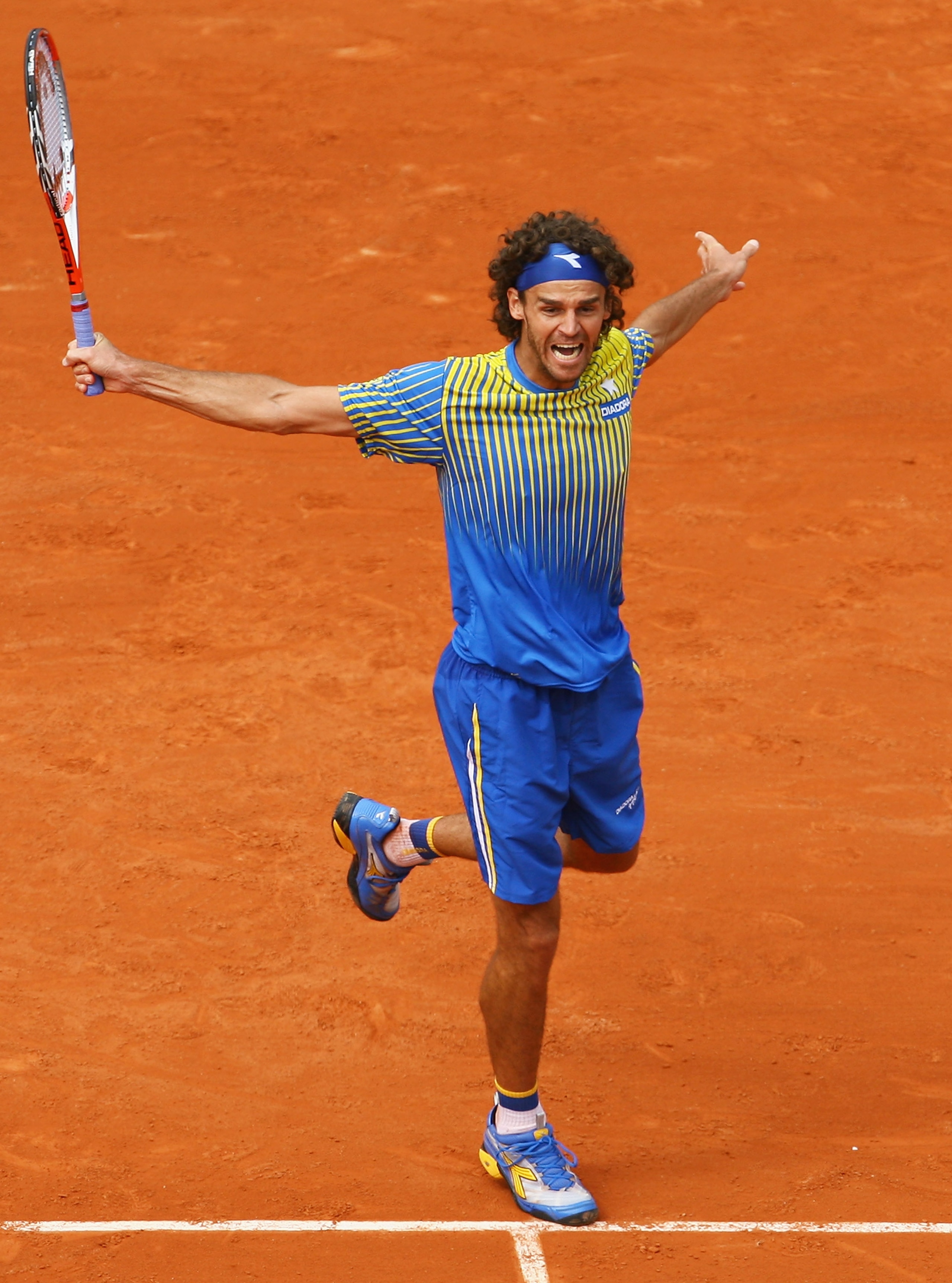 PARIS - MAY 25:  Gustavo Kuerten of Brazil celebrates a point during the Men's Singles first round match against Paul-Henri Mathieu of France on day one of the French Open at Roland Garros on May 25, 2008 in Paris, France. The French Open with be Kuertens