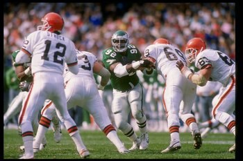 16 Oct 1988:  Defensive tackle Reggie White of the Philadelphia Eagles (center) runs toward quarterback Don Strock of the Cleveland Browns (left) during a game at Cleveland Stadium in Cleveland, Ohio.  The Browns won the game 19-3. Mandatory Credit: Rick