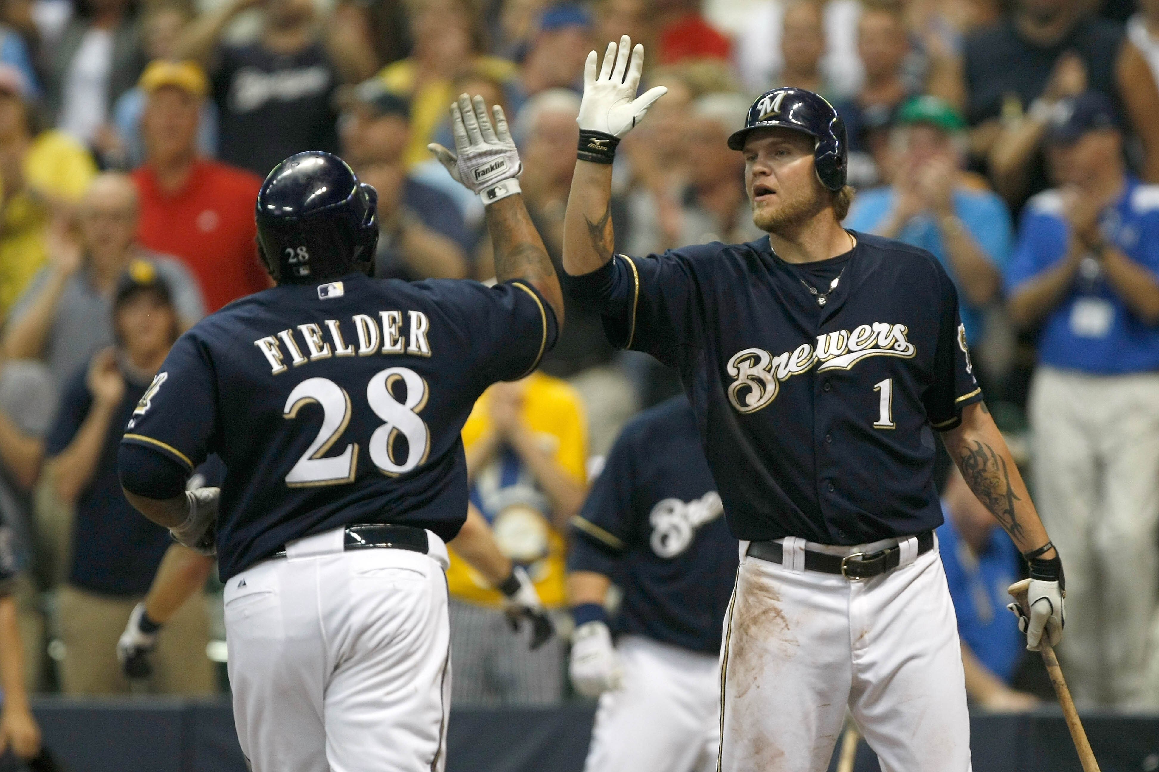 MILWAUKEE, WI - JUNE 8: Prince Fielder #28 of the Milwaukee Brewers is congratulated by Corey Hart #1 after hitting a home run against the New York Mets at Miller Park on June 8, 2011 in Milwaukee, Wisconsin. (Photo by Scott Boehm/Getty Images)