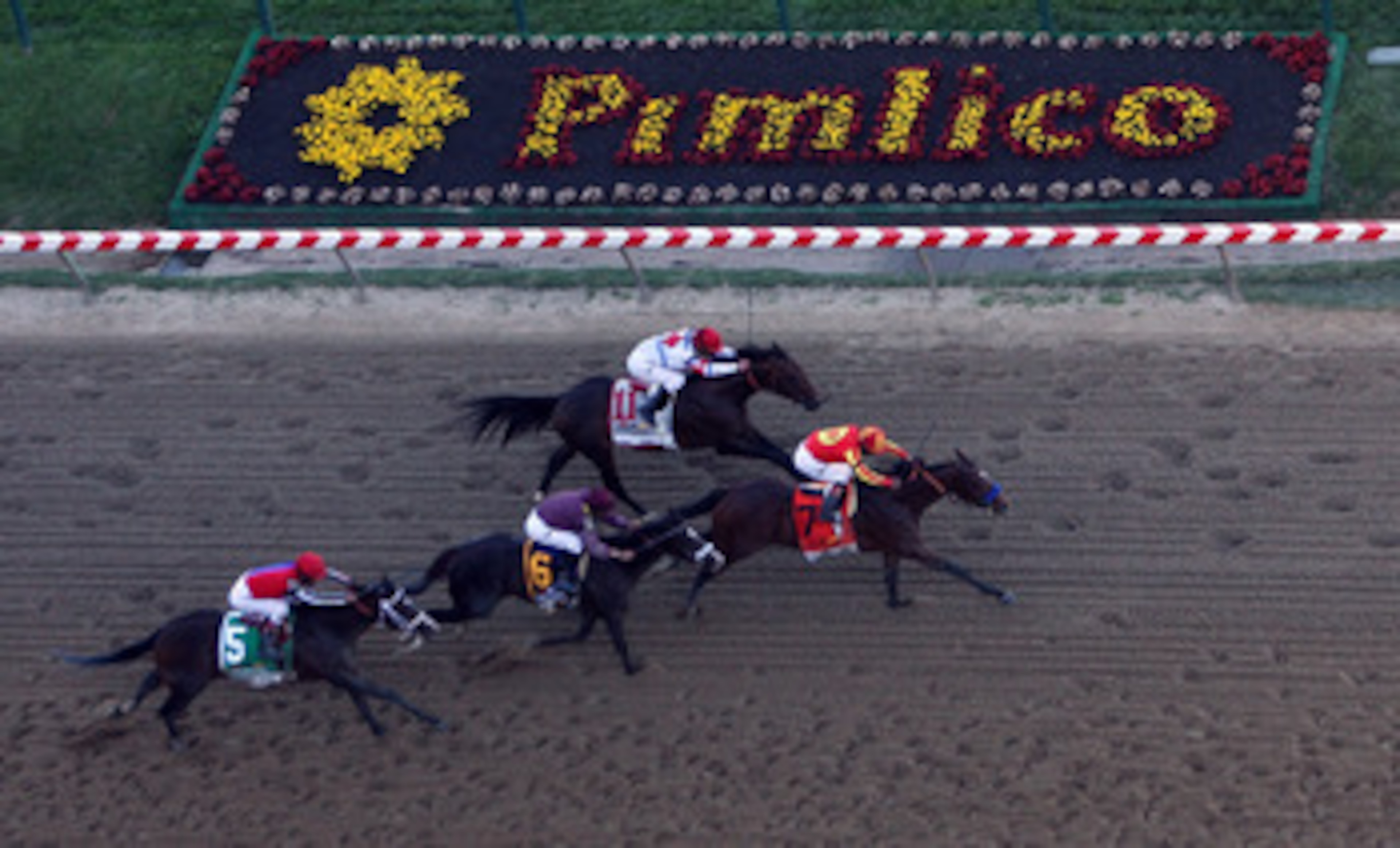 BALTIMORE - MAY 15:  Lookin At Lucky (center), ridden by Martin Garcia #7, holds off First Dude, ridden by Ramon Dominguez #11, Jackson Bend , ridden by Mike Smith #6, and Yawanna Twist, ridden by Edgar Prado #5, down the homestrech to win the 135th runni