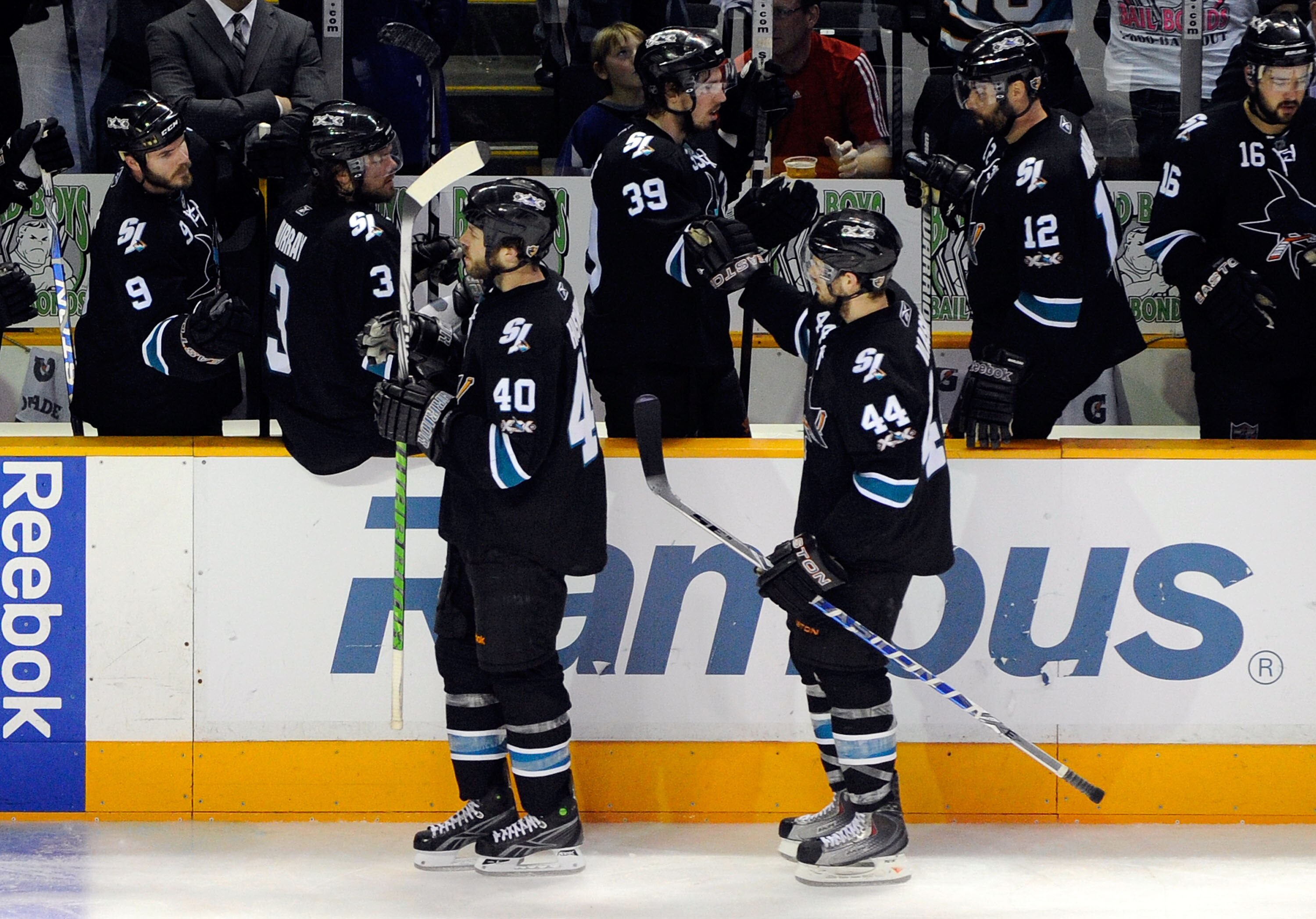 SAN JOSE, CA - MAY 22:  Kent Huskins #40 and Marc-Edouard Vlasic #44 of the San Jose Sharks skate by the Sharks bench to celebrate a goal by Vlasic in the third period in Game Four of the Western Conference Finals during the 2011 Stanley Cup Playoffs at H