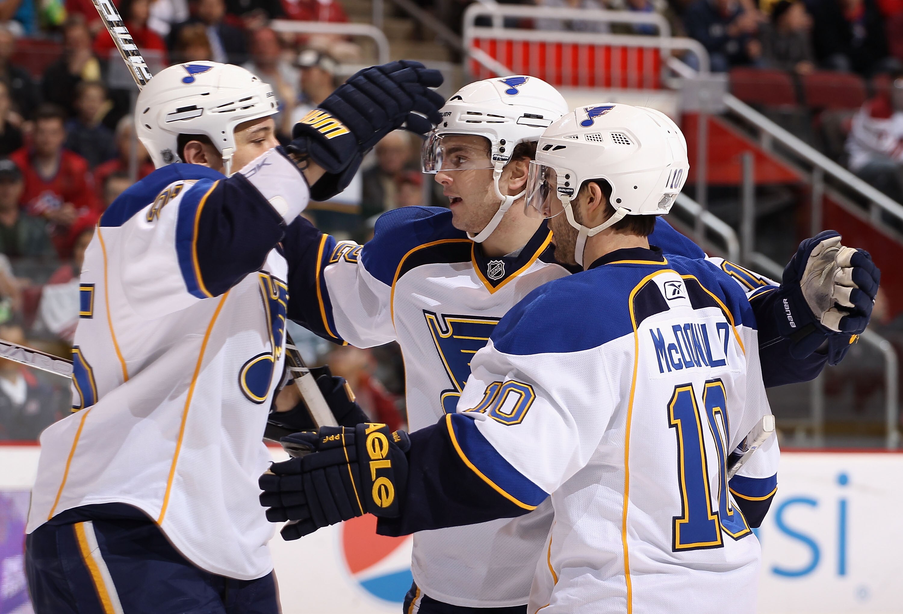 GLENDALE, AZ - MARCH 22:  Kevin Shattenkirk #12 (C) of the St. Louis Blues celebrates with teammates Chris Stewart #25 and Andy McDonald #10 after Shattenkirk scored a first period goal against the Phoenix Coyotes during the NHL game at Jobing.com Arena o