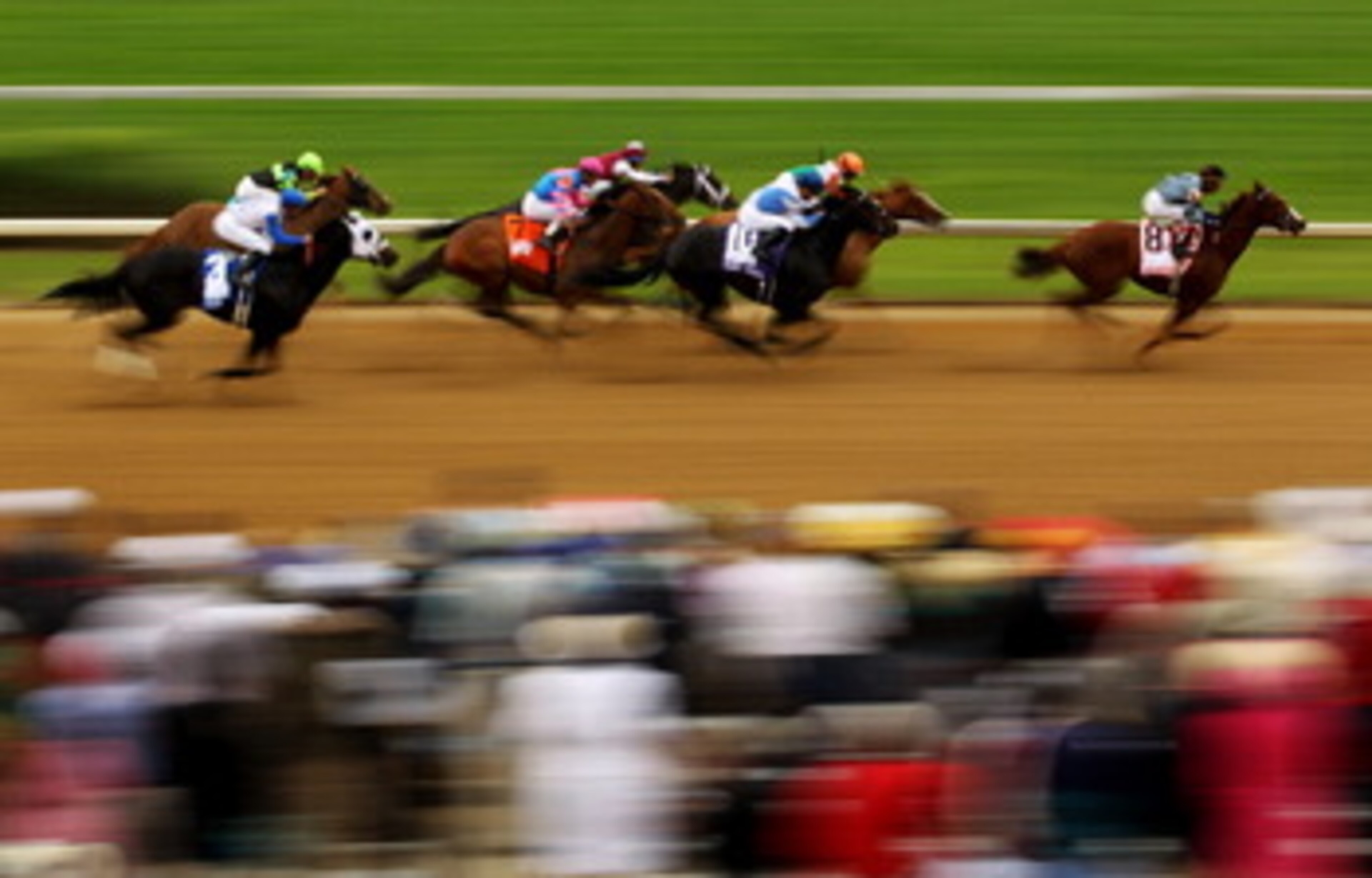 LOUISVILLE, KY - MAY 07:  Horses run down the front stretch as they race during the third race on the day of the 137th Kentucky Derby at Churchill Downs on May 7, 2011 in Louisville, Kentucky.  (Photo by Al Bello/Getty Images)