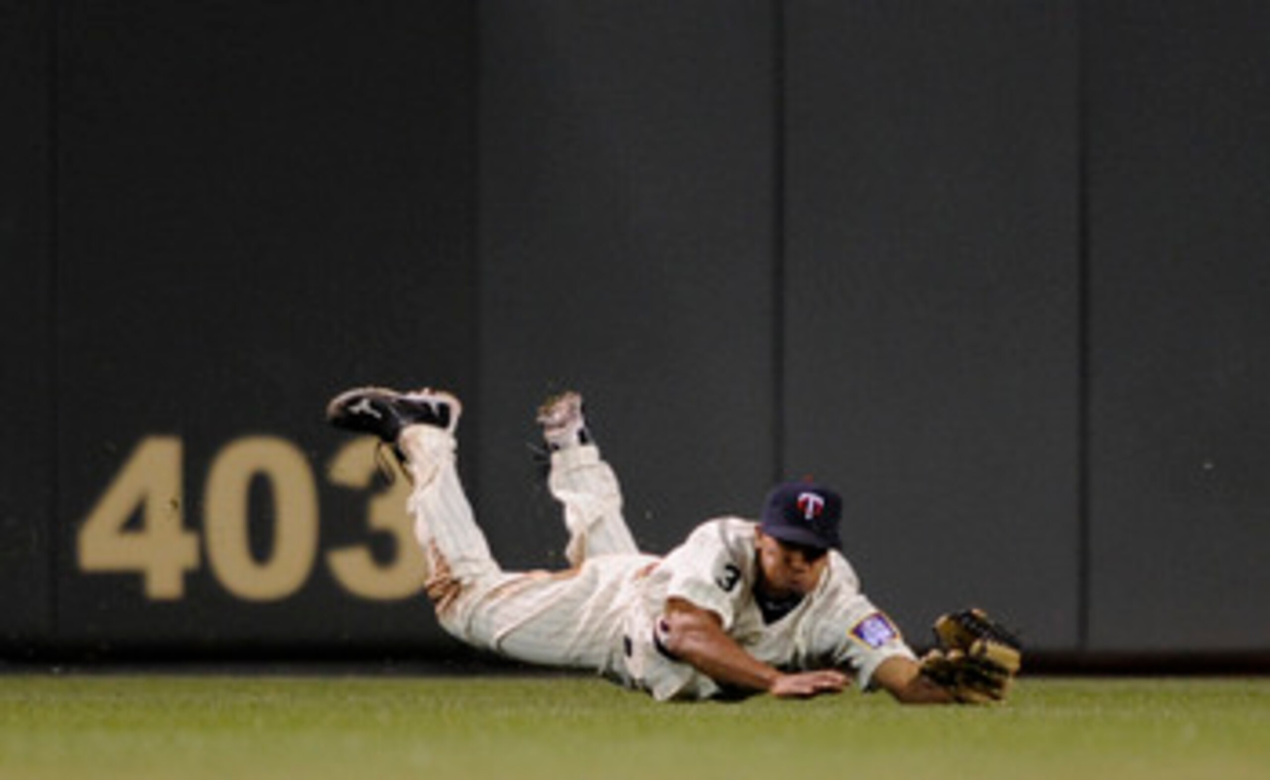 MINNEAPOLIS, MN - JUNE 9: Ben Revere #11 of the Minnesota Twins dives for a ball hit into play by the Texas Rangers during the eighth inning of their game on June 9, 2011 at Target Field in Minneapolis, Minnesota. Twins defeated the Rangers 5-4. (Photo by