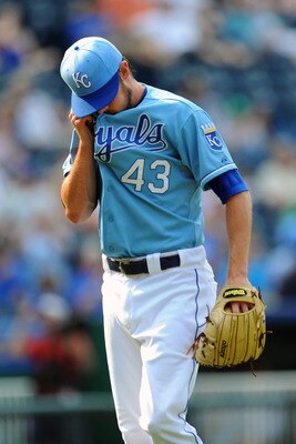 KANSAS CITY, MO - JUNE 9:  Aaron Crow #43 of the Kansas City Royals wipes his face as he walks back to the dugout following the eight inning against the Toronto Blue Jays at Kauffman Stadium on June 9, 2011 in Kansas City, Missouri. The Royals defeated th