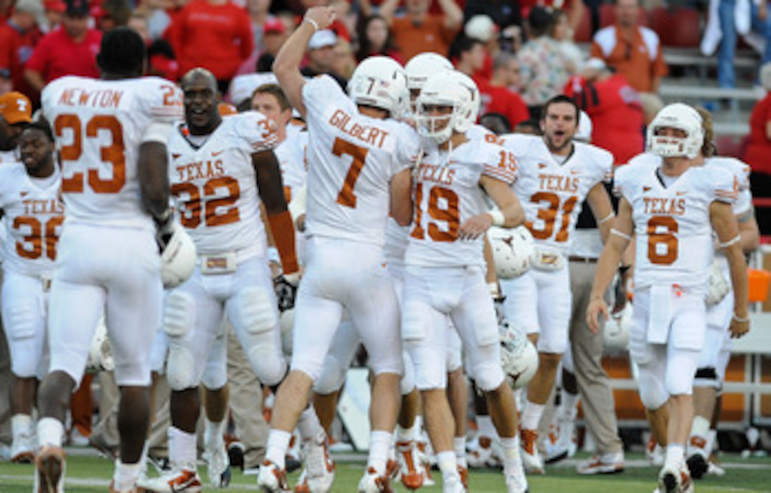 LINCOLN, NE - OCTOBER 16: Quarterback Garrett Gilbert #7 of the Texas Longhorns runs toward his teammates ofter the final of their game against the Nebraska Cornhuskers at Memorial Stadium on October 16, 2010 in Lincoln, Nebraska. Texas Defeated Nebraska LINCOLN, NE - OCTOBER 16: Quarterback Garrett Gilbert #7 of the Texas Longhorns runs toward his teammates ofter the final of their game against the Nebraska Cornhuskers at Memorial Stadium on October 16, 2010 in Lincoln, Nebraska. Texas Defeated Nebraska