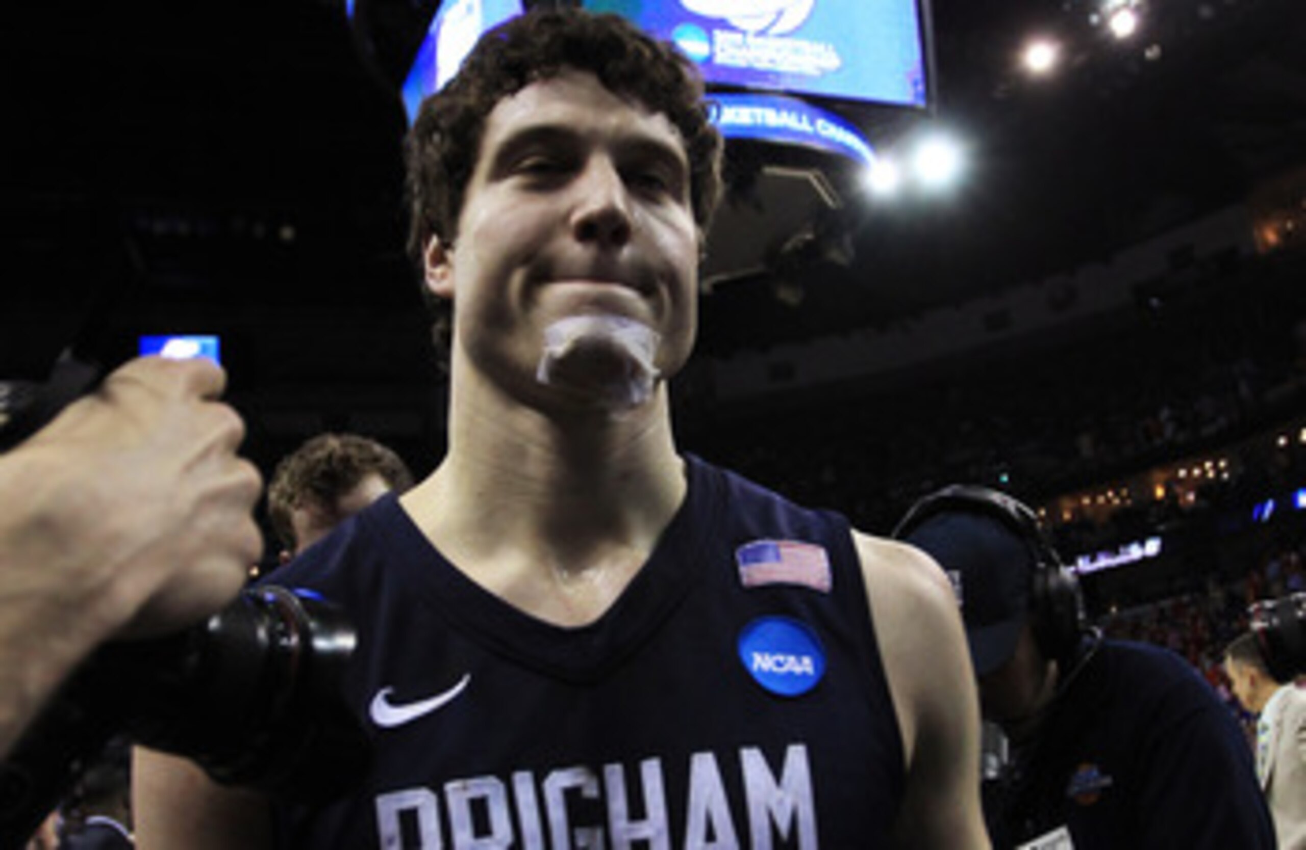 NEW ORLEANS, LA - MARCH 24:  Jimmer Fredette #32 of the Brigham Young Cougars walks off of the court rejected after their 74 to 83 loss to the Florida Gators in the Southeast regional of the 2011 NCAA men's basketball tournament at New Orleans Arena on Ma
