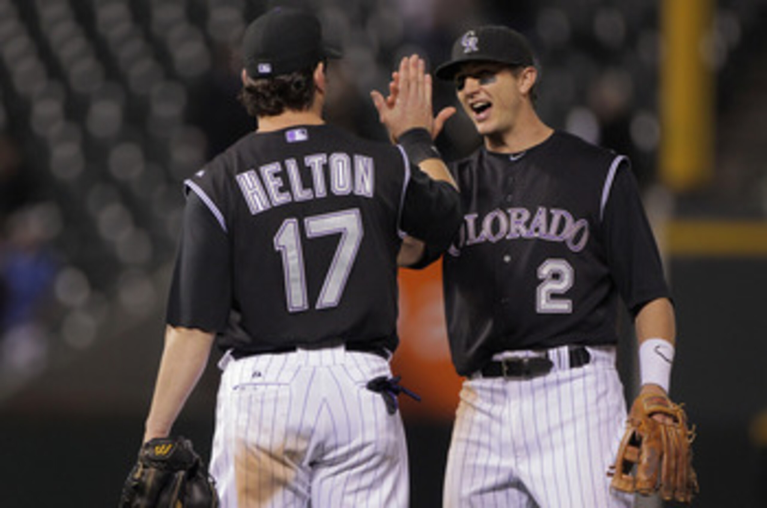DENVER, CO - JUNE 09:  Todd Helton #17 and Troy Tulowitzki #2 of the Colorado Rockies celebrate their 9-7 victory over the Los Angeles Dodgers at Coors Field on June 9, 2011 in Denver, Colorado.  (Photo by Doug Pensinger/Getty Images)