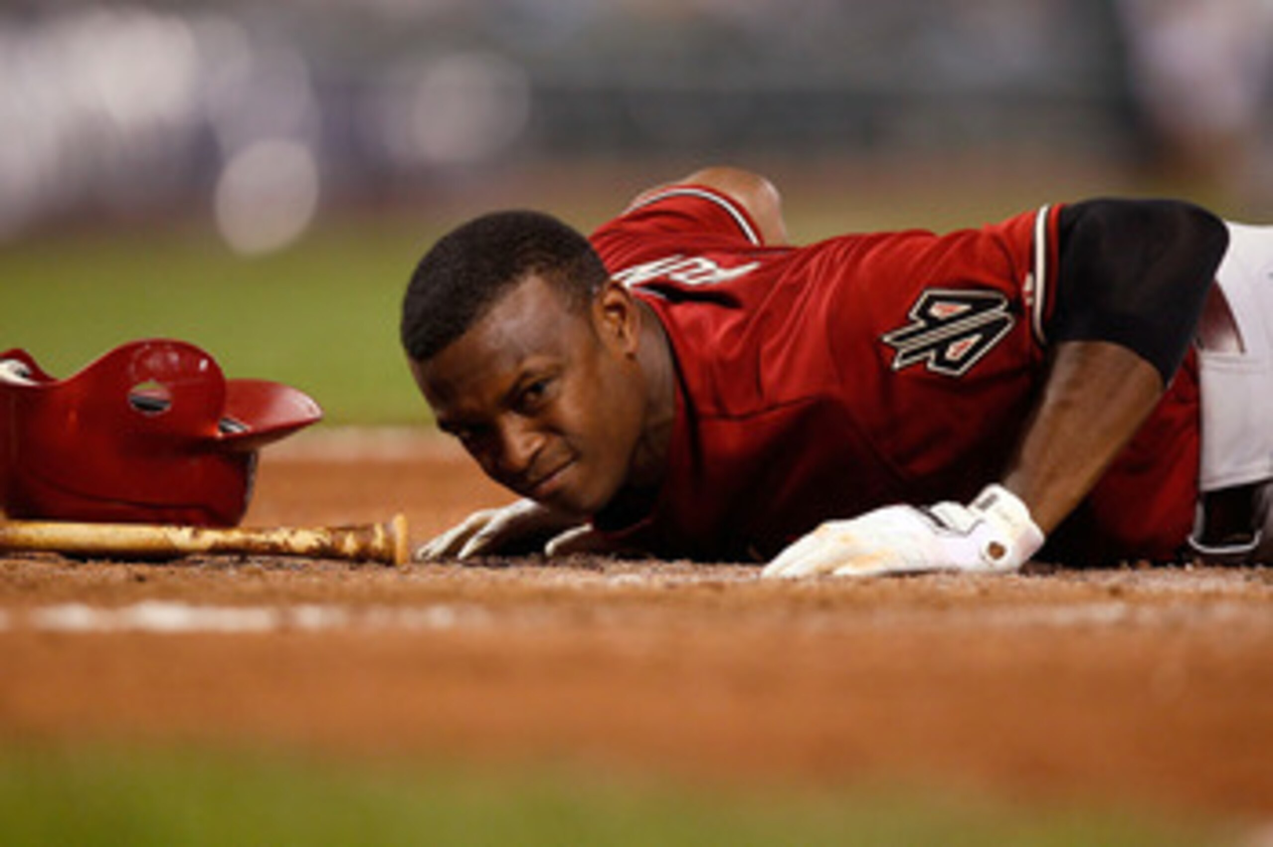 PITTSBURGH - JUNE 08:  Justin Upton #10 of the Arizona Diamondbacks lays on the ground at home plate after being hit by a pitch against the Pittsburgh Pirates during the game on June 8, 2011 at PNC Park in Pittsburgh, Pennsylvania.  (Photo by Jared Wicker