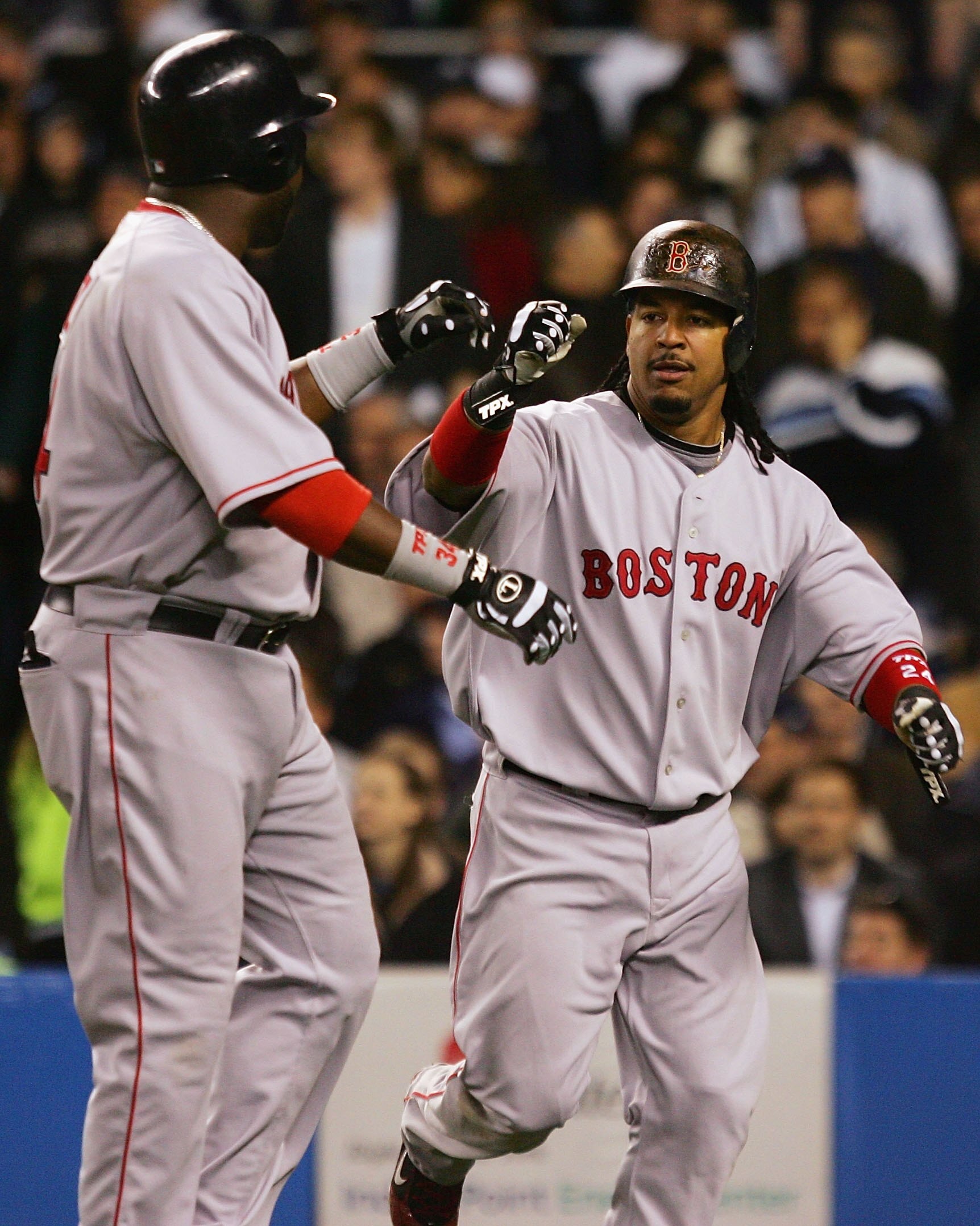 NEW YORK - APRIL 16: Manny Ramirez #24 and David Ortiz #34 of the Boston Red Sox celebrate after scoring against the New York Yankees on April 16, 2008 at Yankee Stadium in the Bronx borough of New York City. The Yankees won the game 15-9. (Photo by Jim M